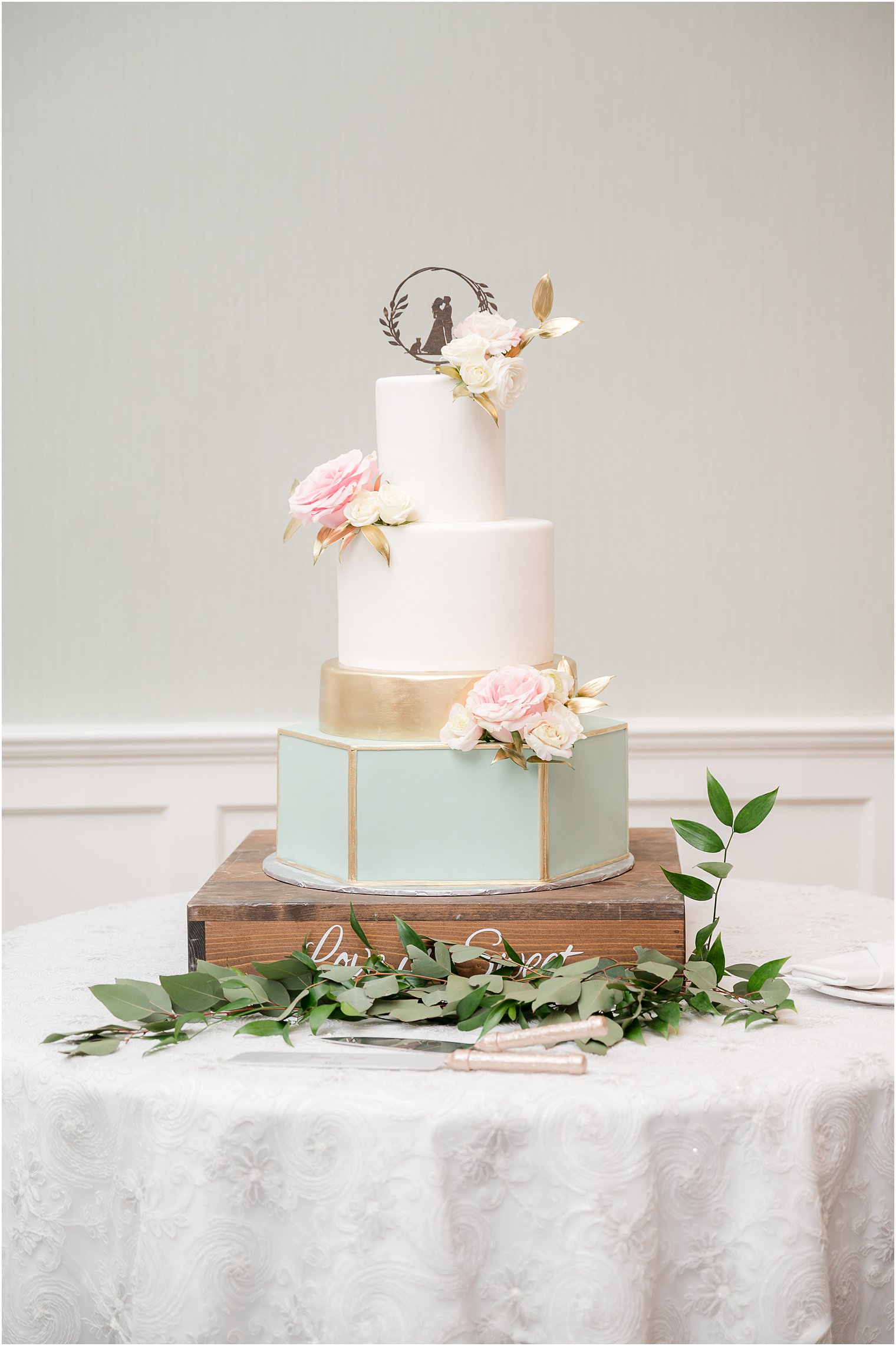 tiered wedding cake with gold and teal details at Clark's Landing Yacht Club