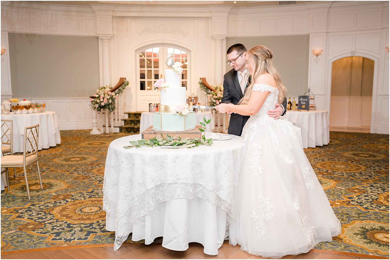 bride and groom cut tiered wedding cake