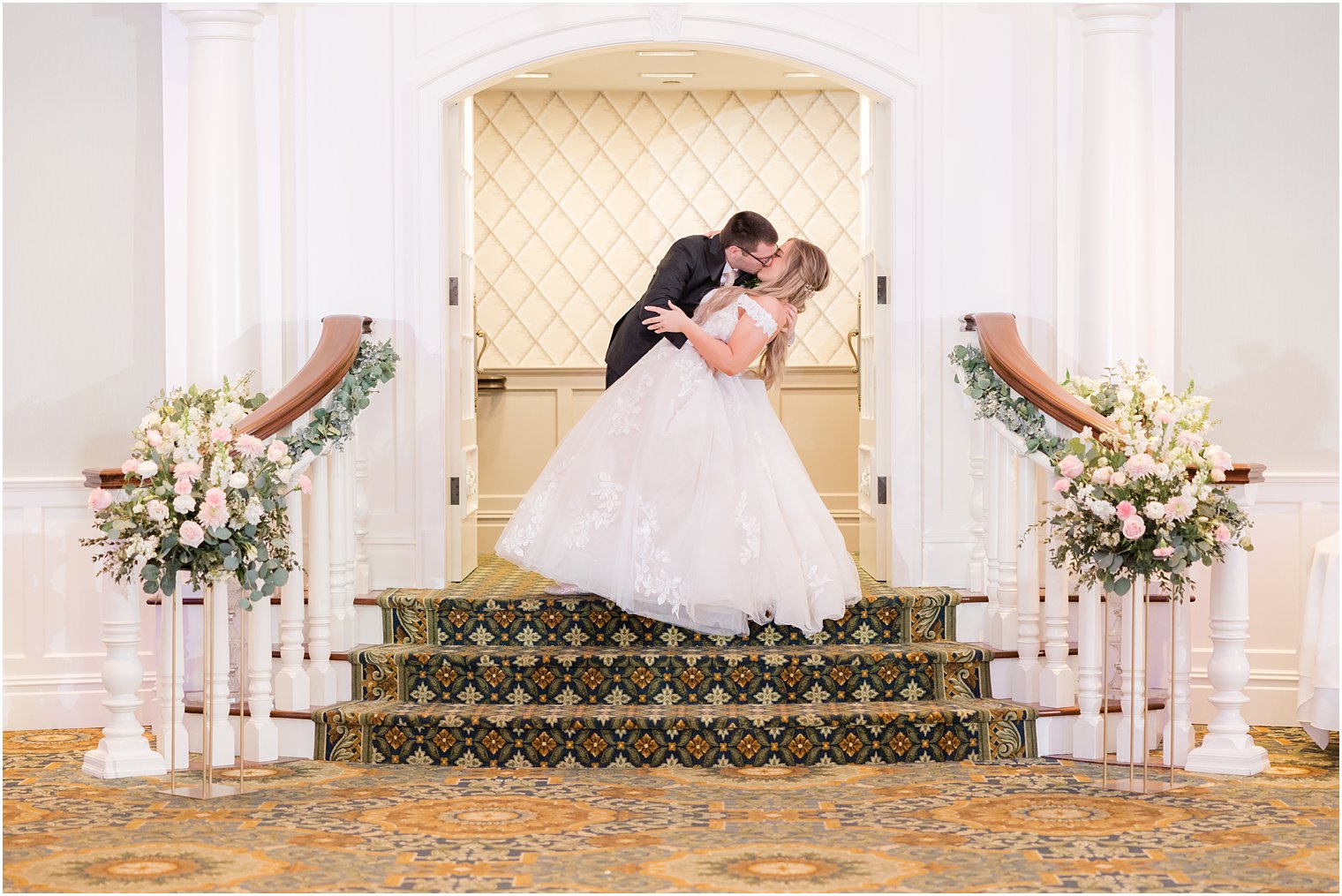 newlyweds kiss on staircase at Clark's Landing Yacht Club