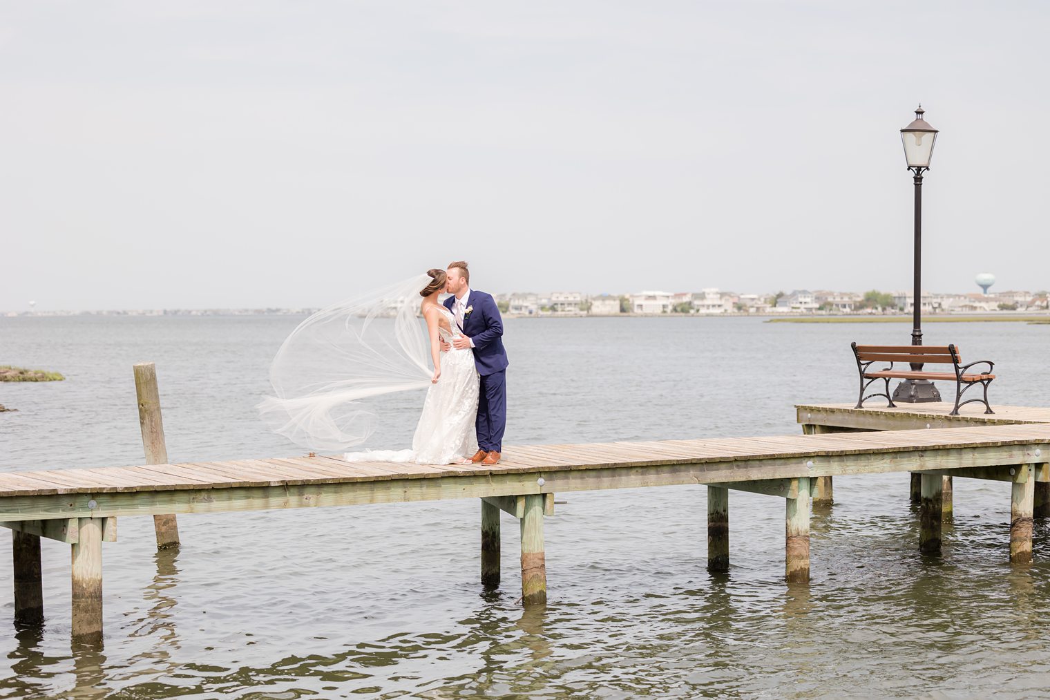 Bride and Groom kissing on the bridge at Bonnet Island Estate