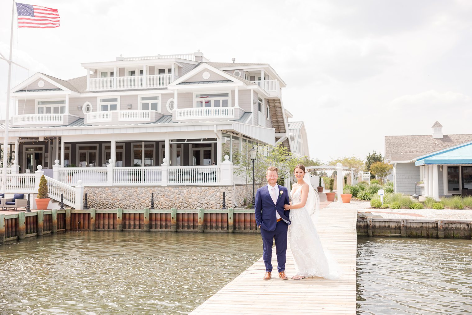 Bride holding his fiance arm on the bridge at Bonnet Island Estate