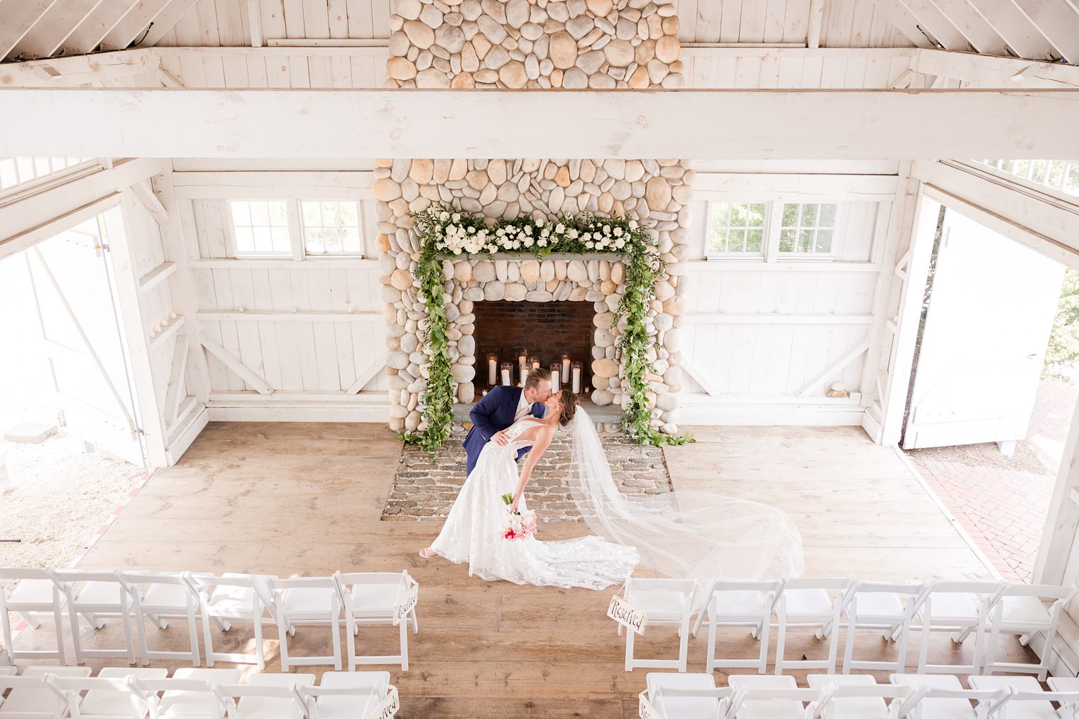 Groom and bride kissing in front of the altar at Bonnet Island Estate