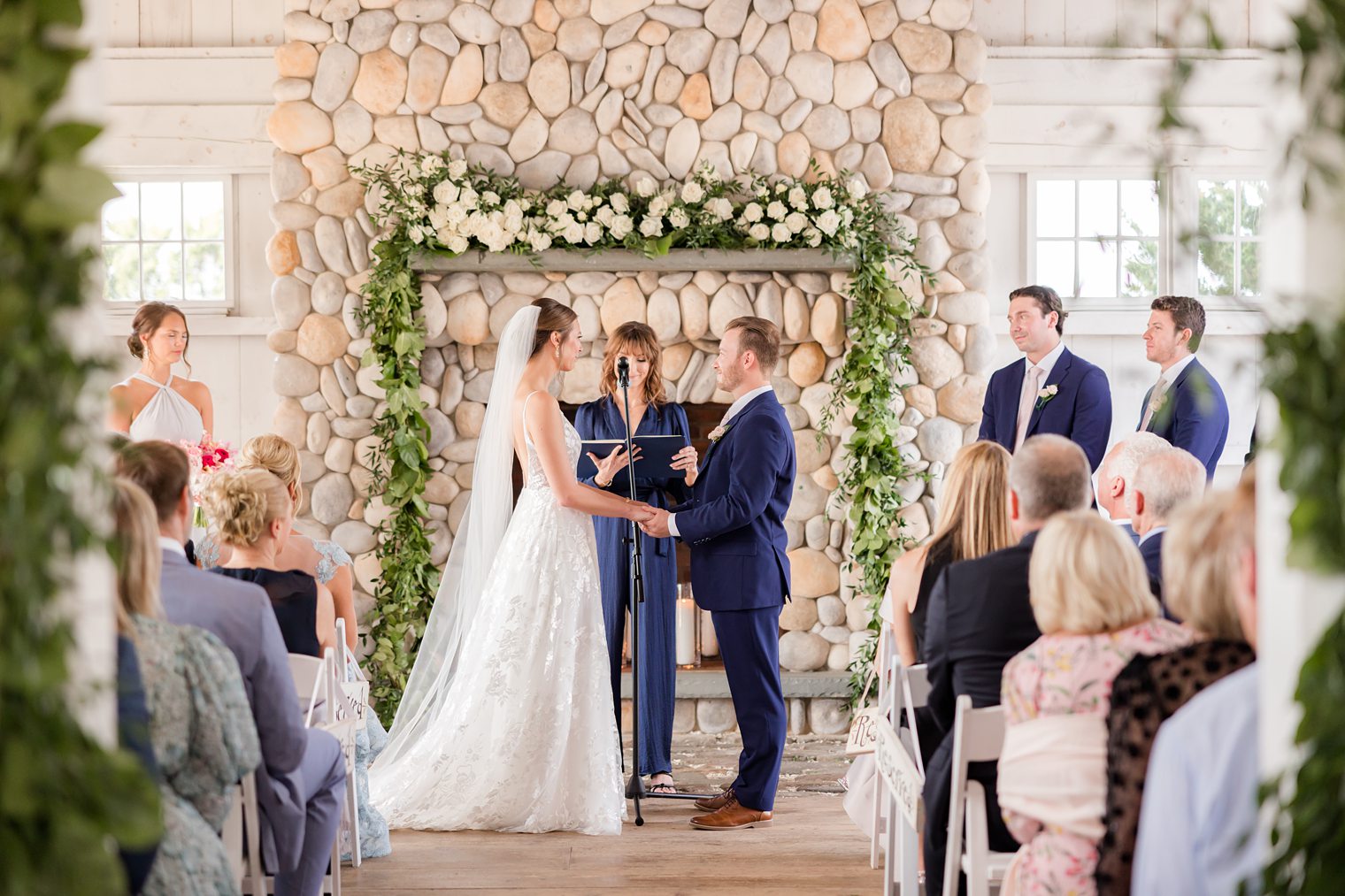 Bride and Groom holding hands in the aisle at Bonnet Island Estate