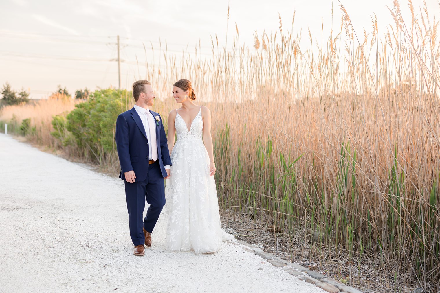 Mr and Mrs taking a walk to enjoy the sunset in their wedding day at Bonnet Island Estate