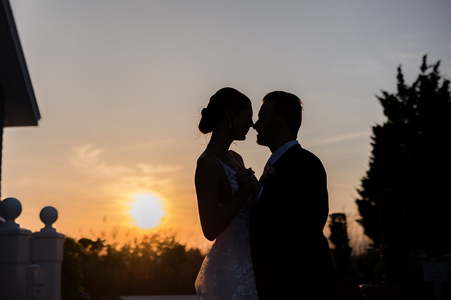 In love couple, being romantic with a beautiful sunset of background at Bonnet Island Estate
