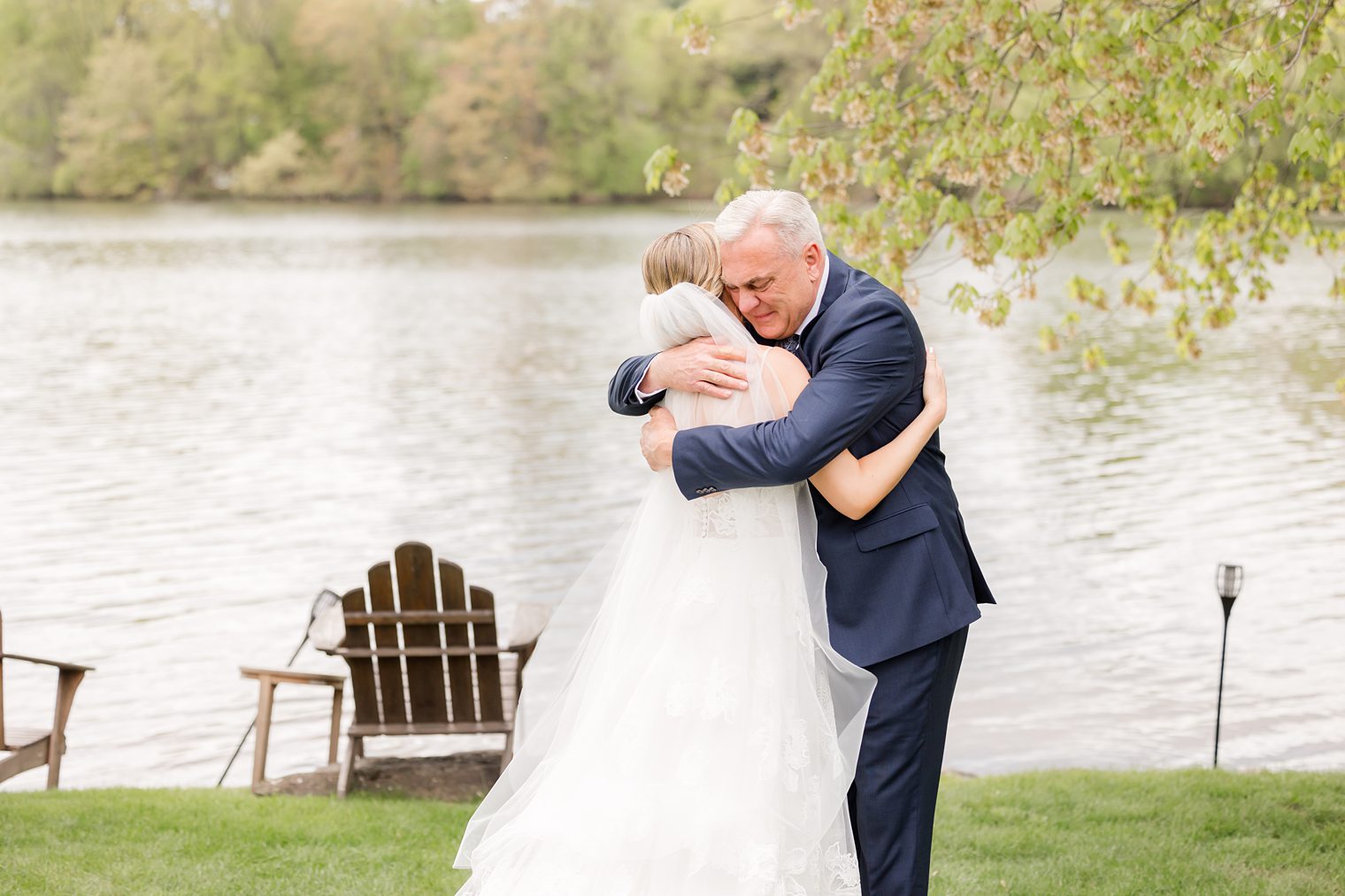 Father of the bride hugging his daughter after sharing their first look