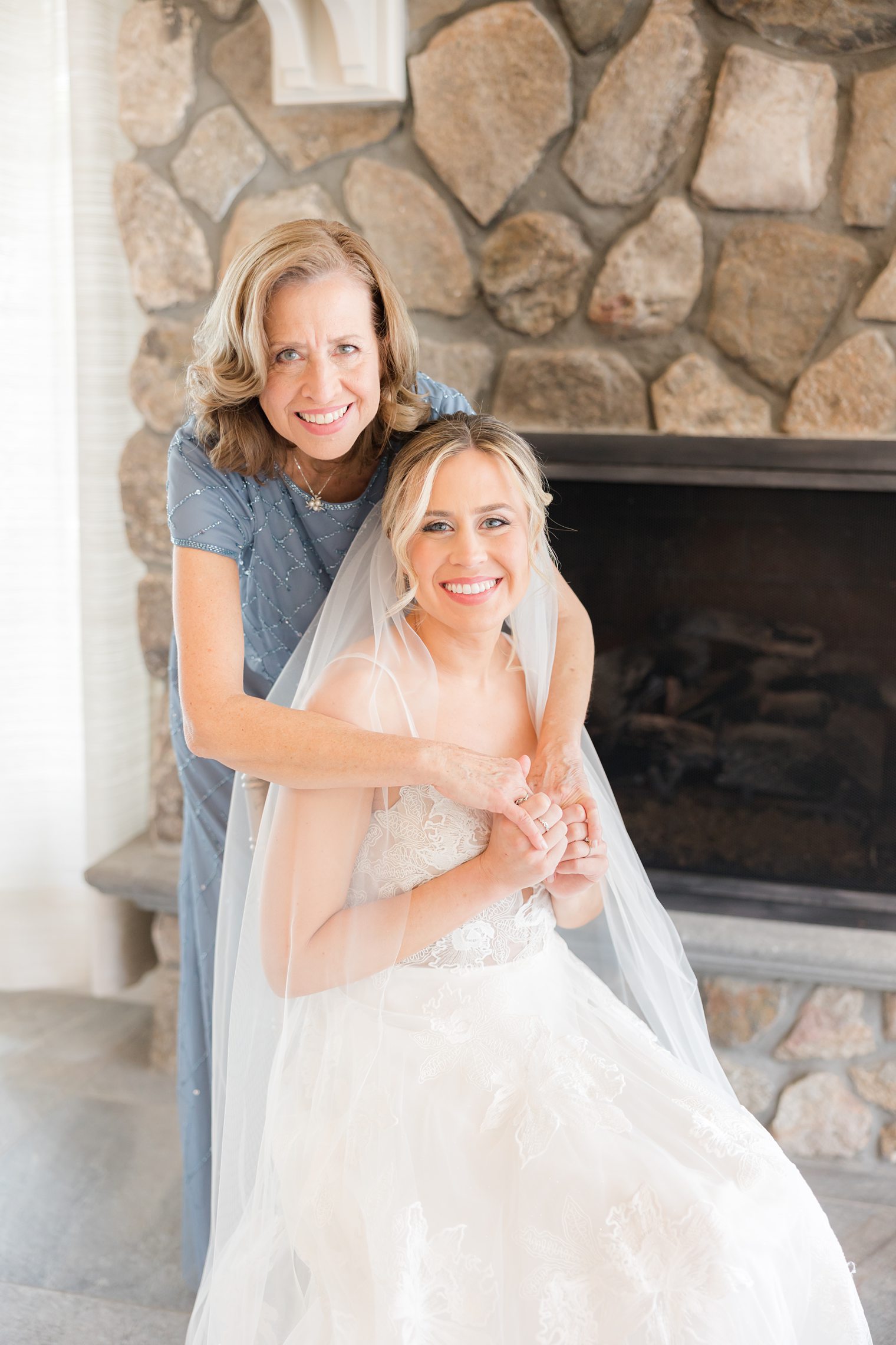 mother of the bride hugging her daughter 