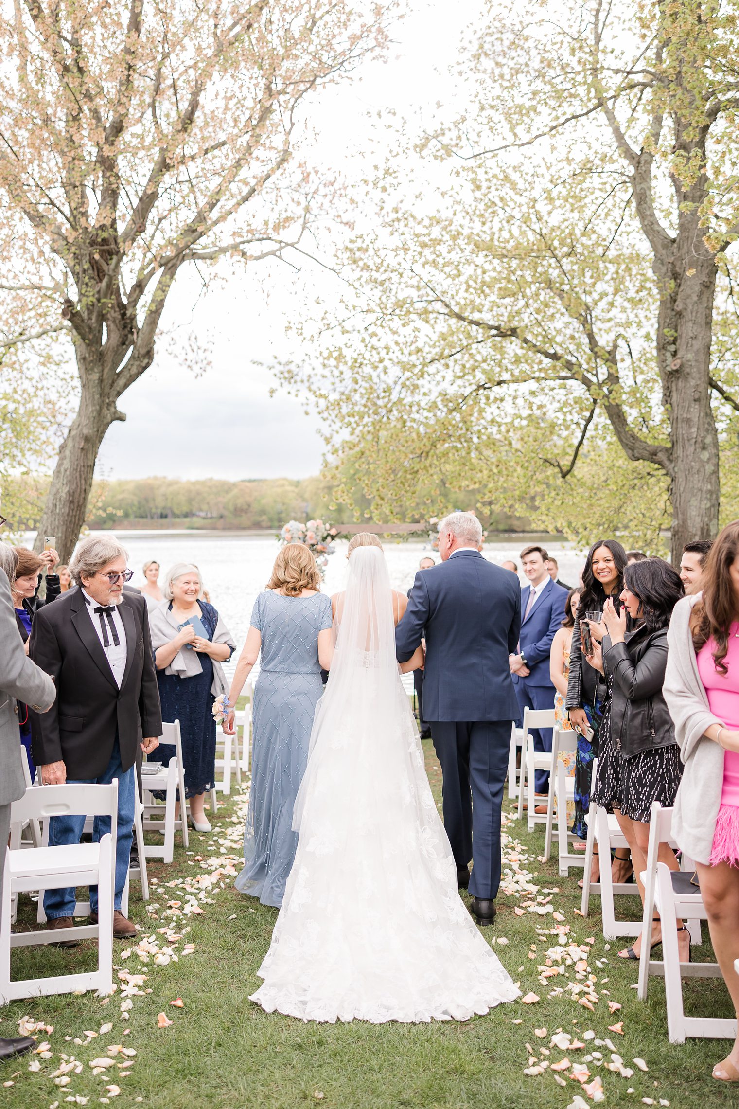 Mother and Father walking down the aisle with her daughter at Indian Trail Club