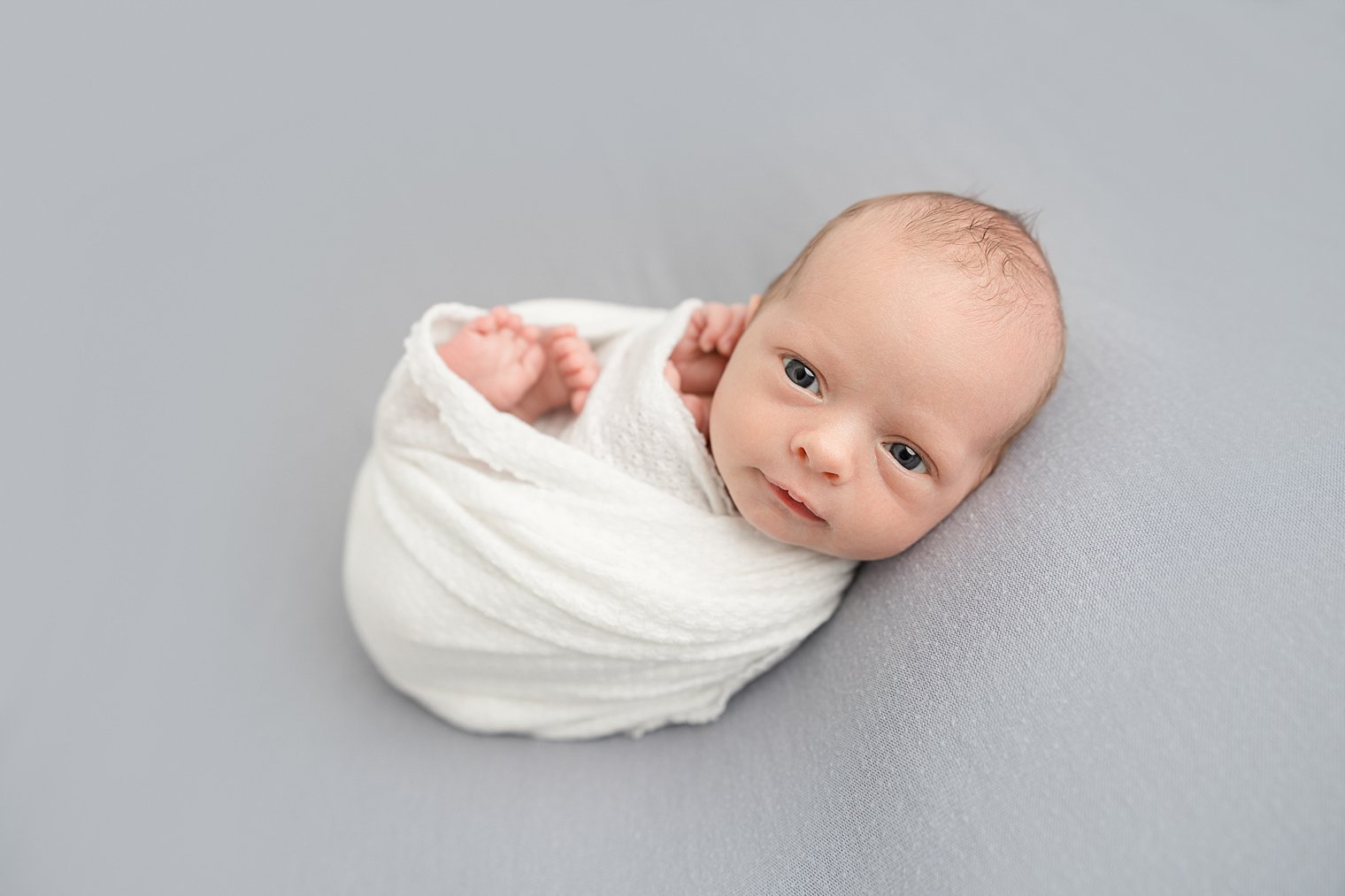 newborn baby boy with his eyes open