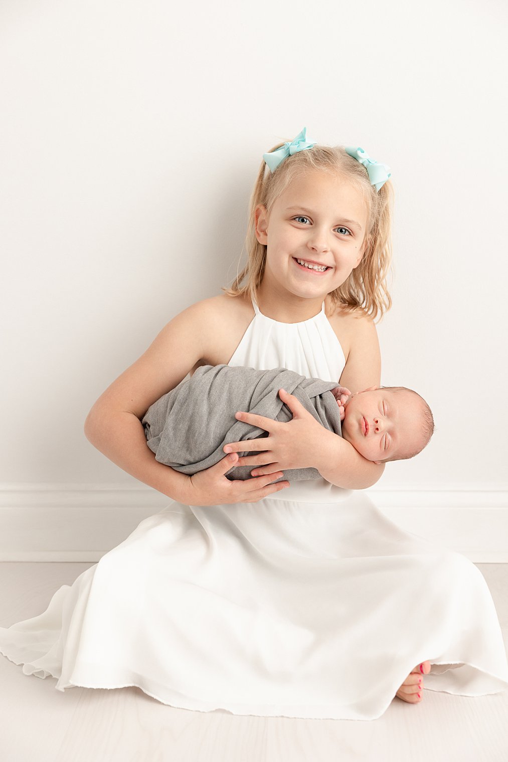 big sister with newborn brother during studio session by Point Pleasant NJ Newborn Photographer