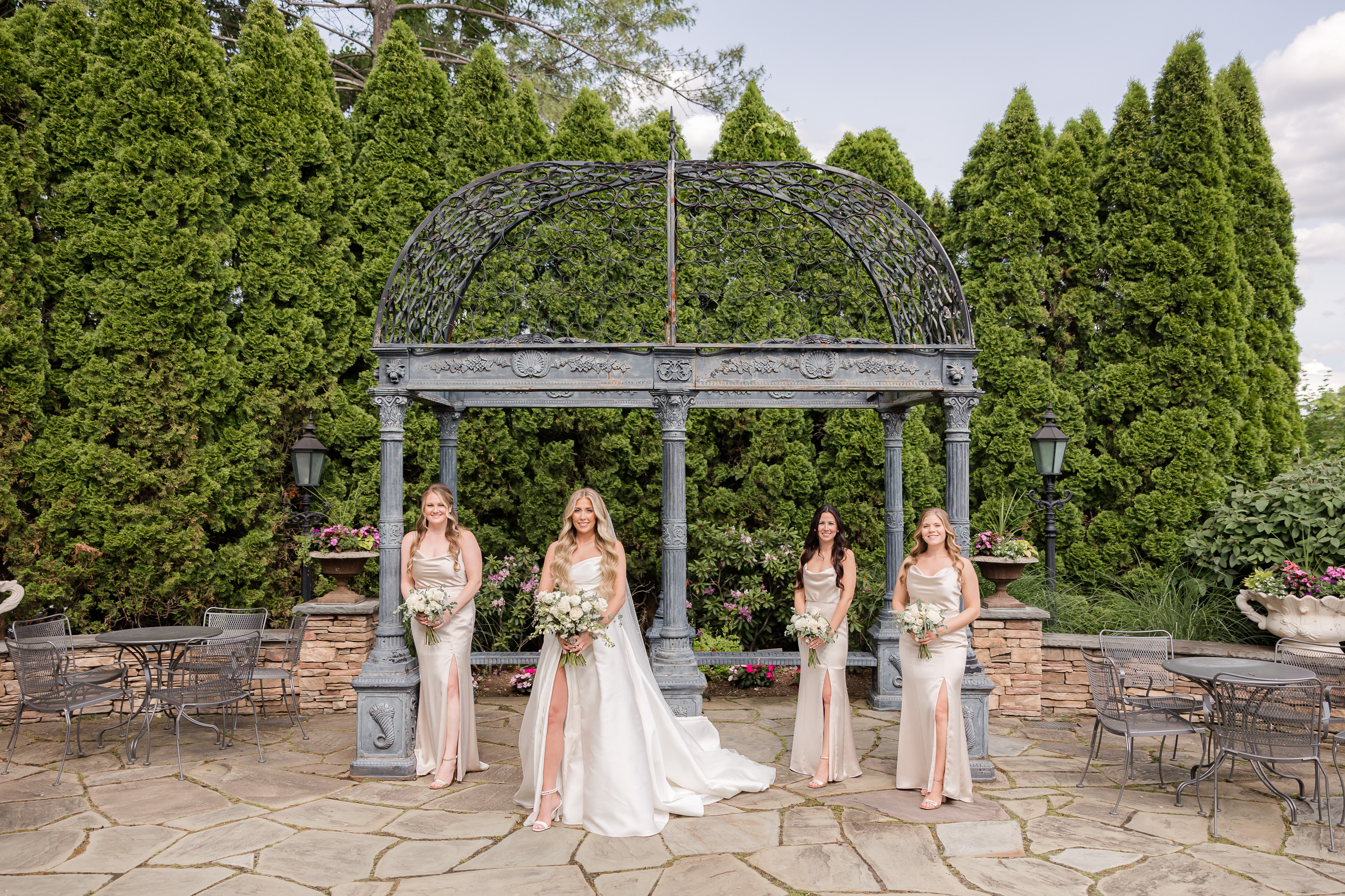Bride posing with her bridesmaids before walking to the aisle 