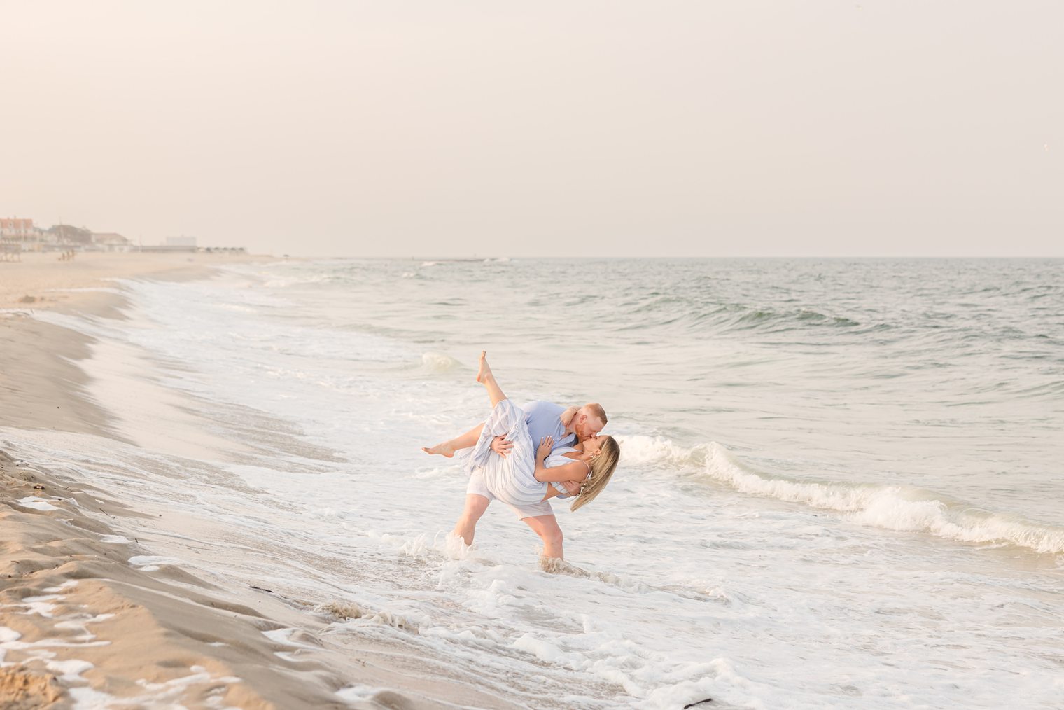 Fiancé holding up her future wife in the beach