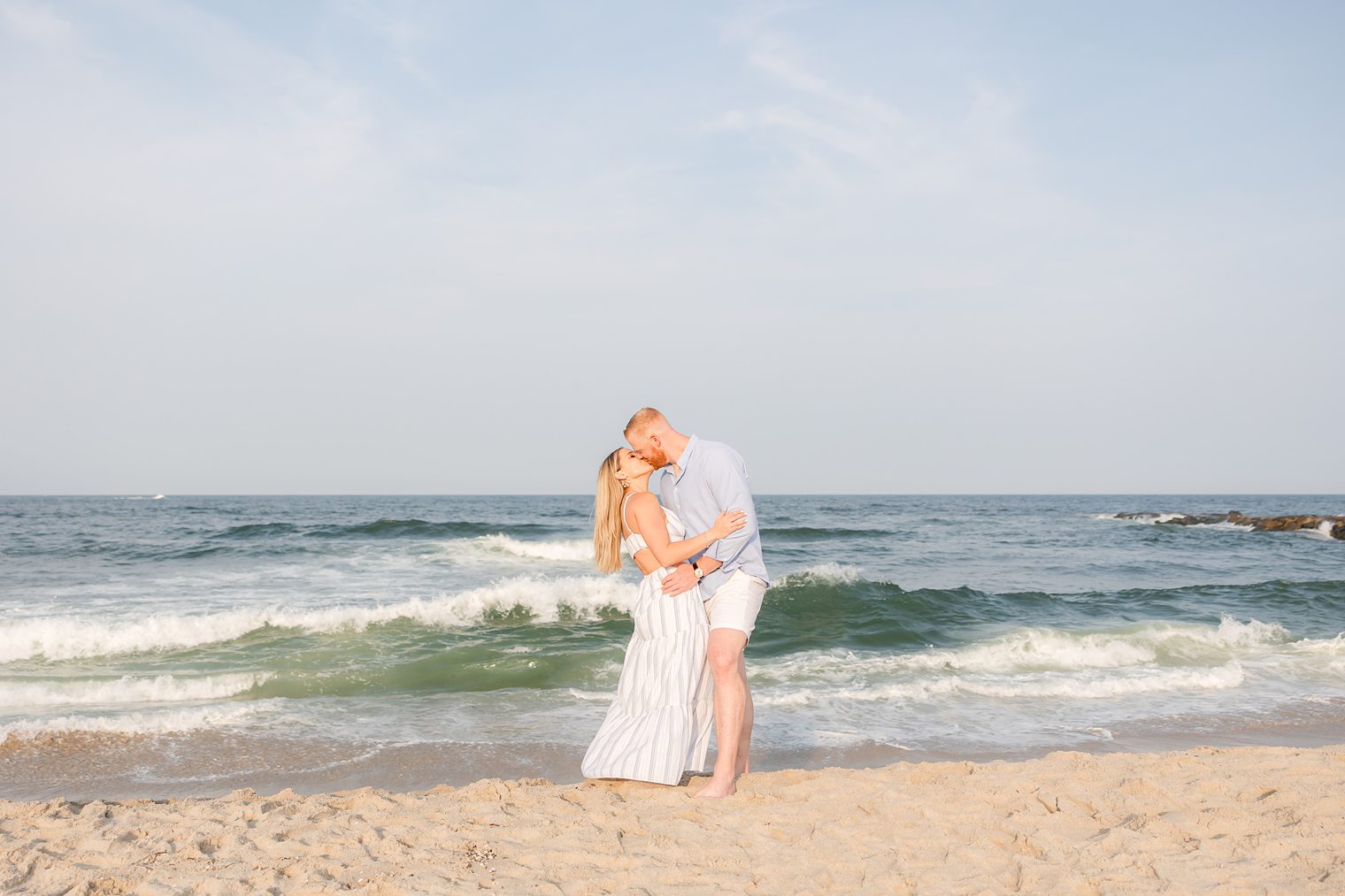 fiancé and bride kissing while they enjoy a beautiful backdrop 