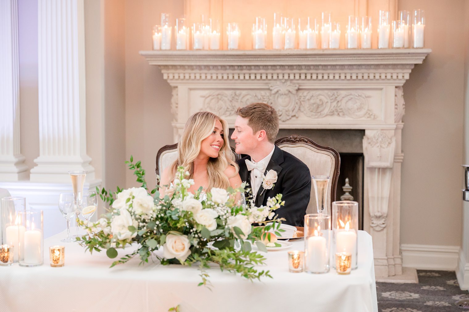 husband and wife being romantic at their sweet heart table