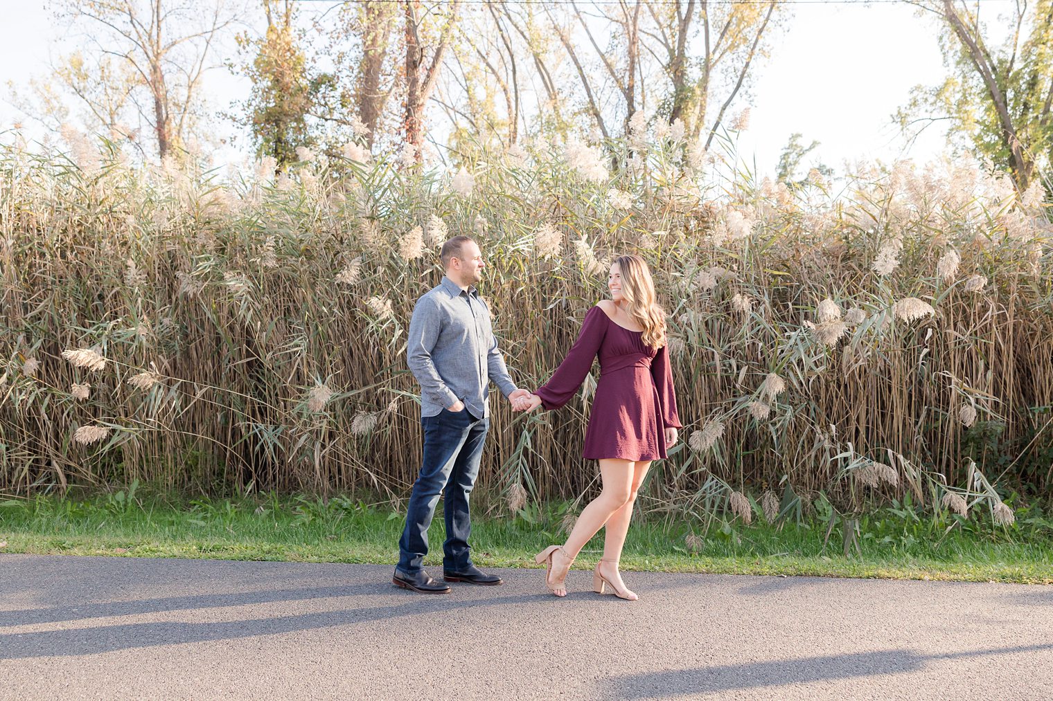 Couple holding hands walking around the space