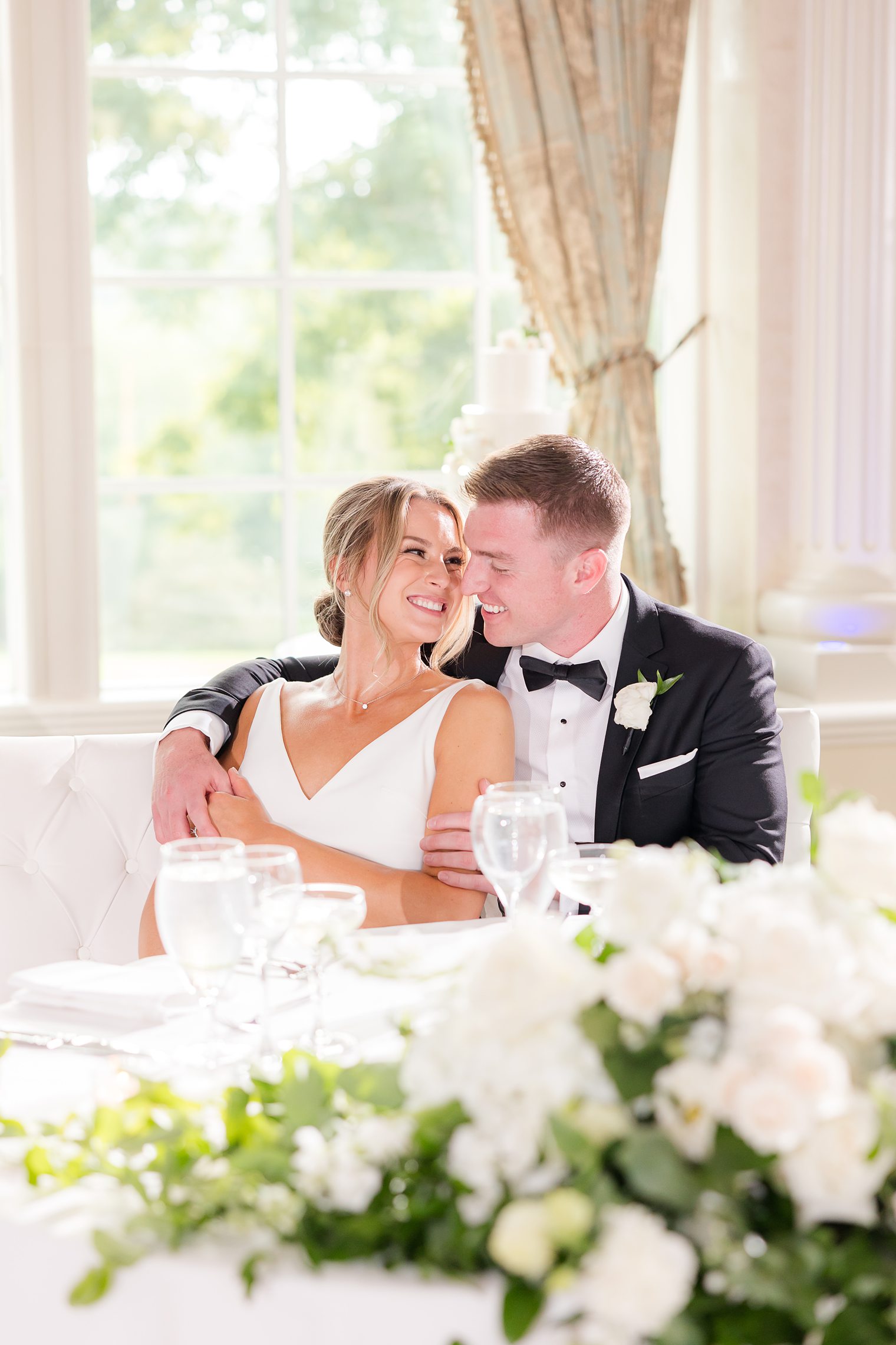 husband and wife sitting in their sweet heart table