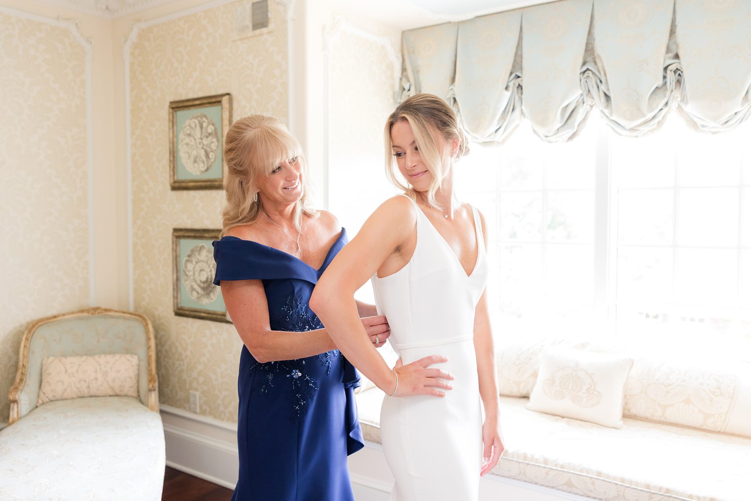 mother of the bride helping her to get ready