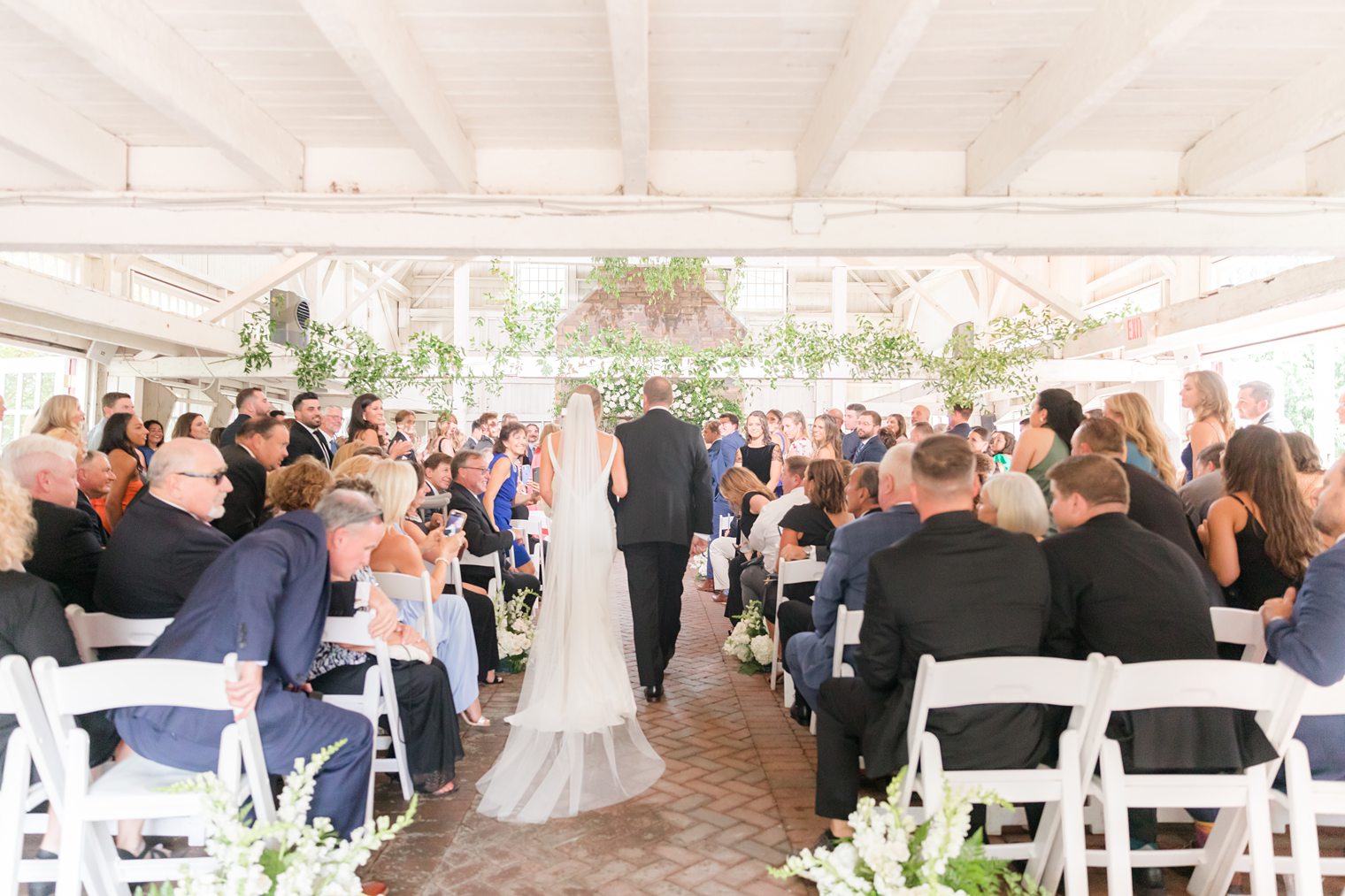 Bride walking into the aisle with her father 