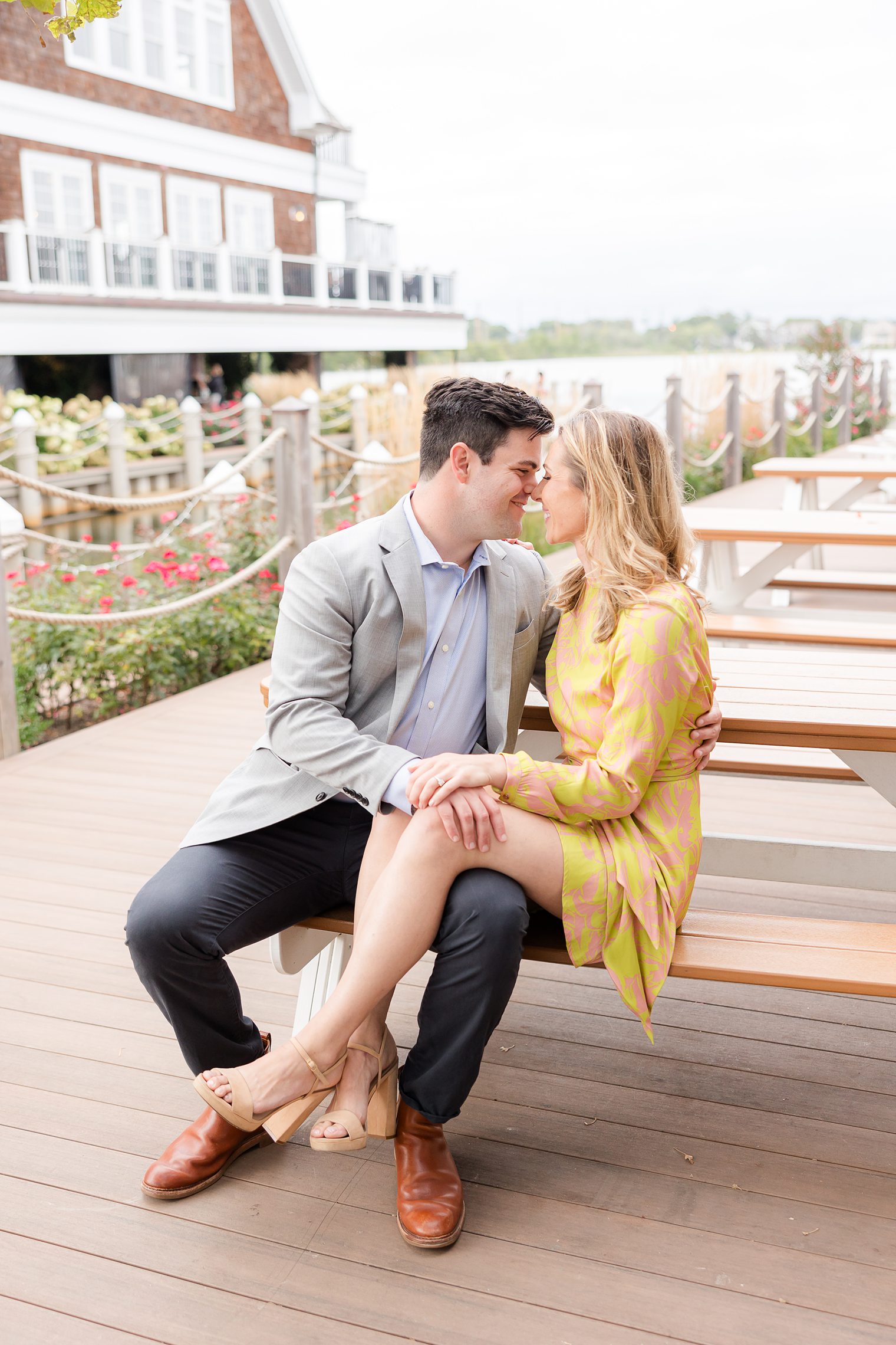 Fiancé and bride sitting in a bench looking each other 