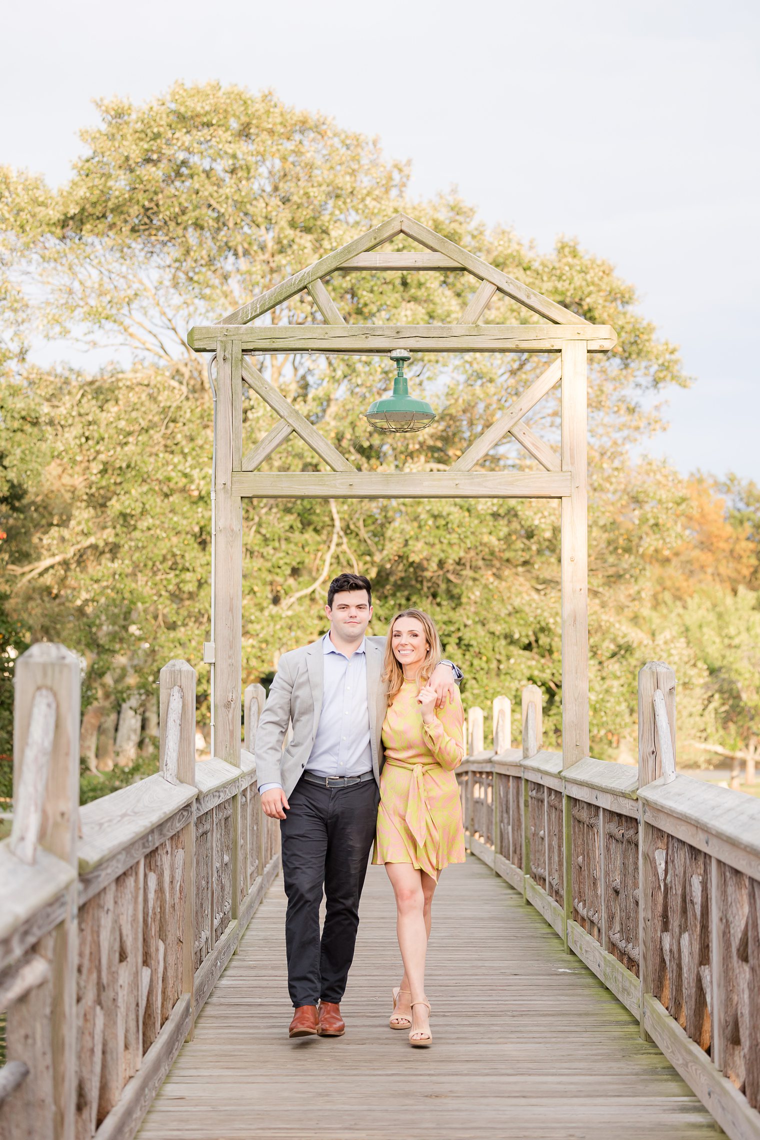 fiancé and bride walking on the bridge at Bay Head