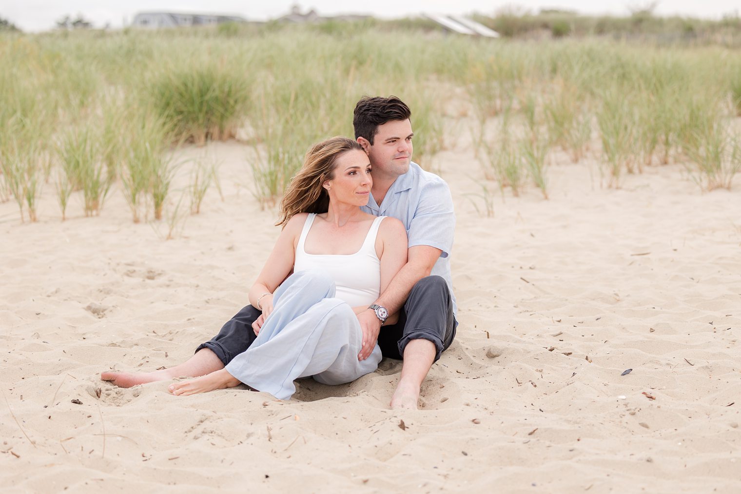 Fiancé and bride looking to the horizon, admiring the beach 