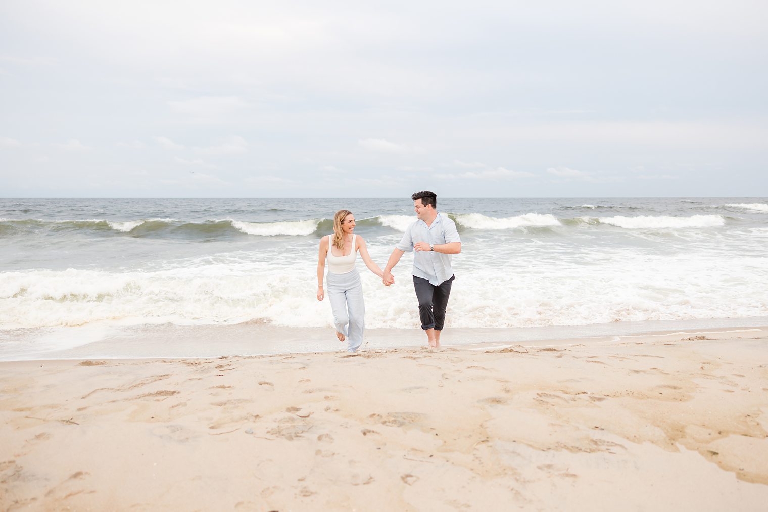 fiancé and bride running in the beach