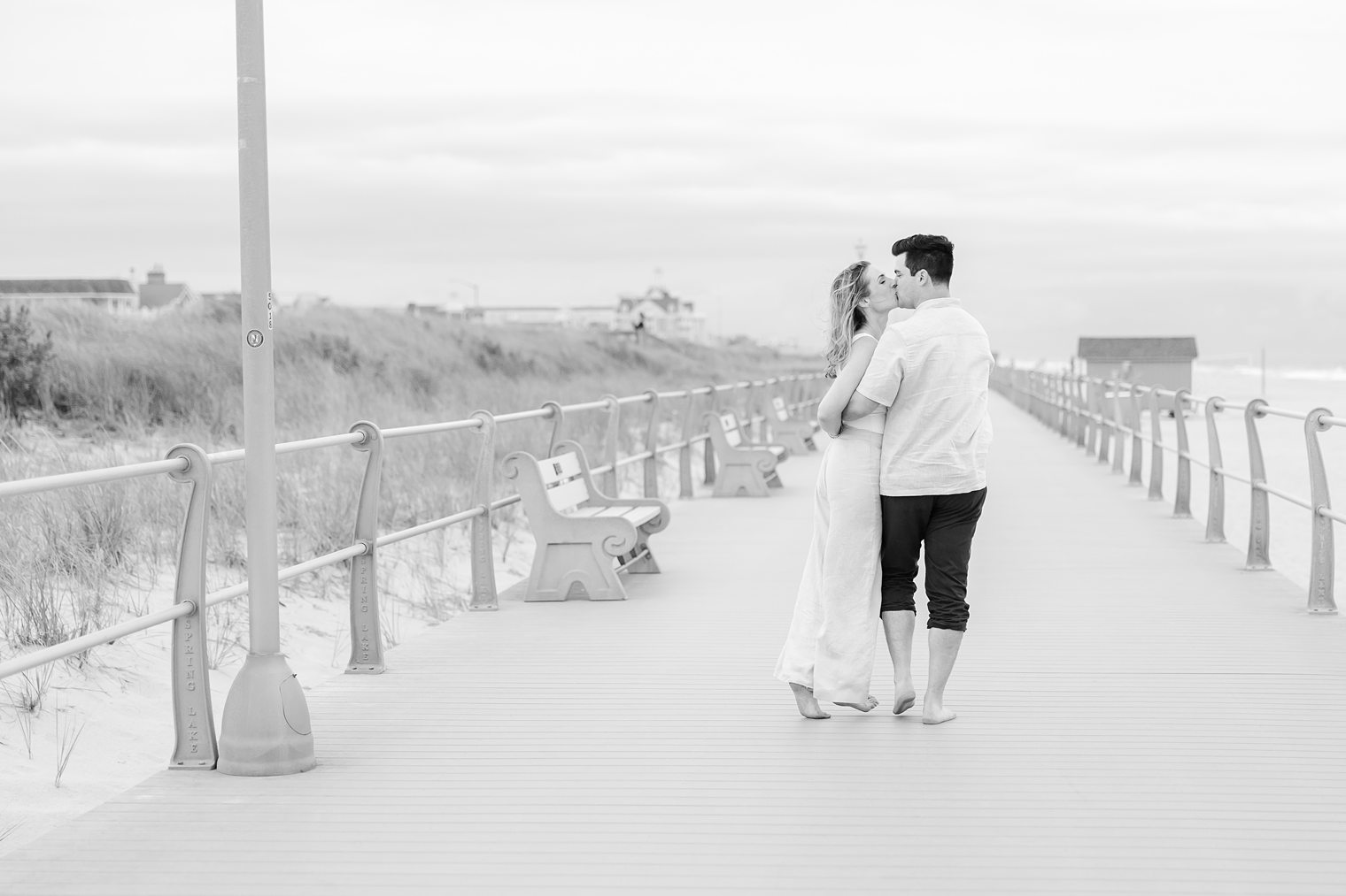 in love couple sharing a kiss in their engagement session at Bay Head