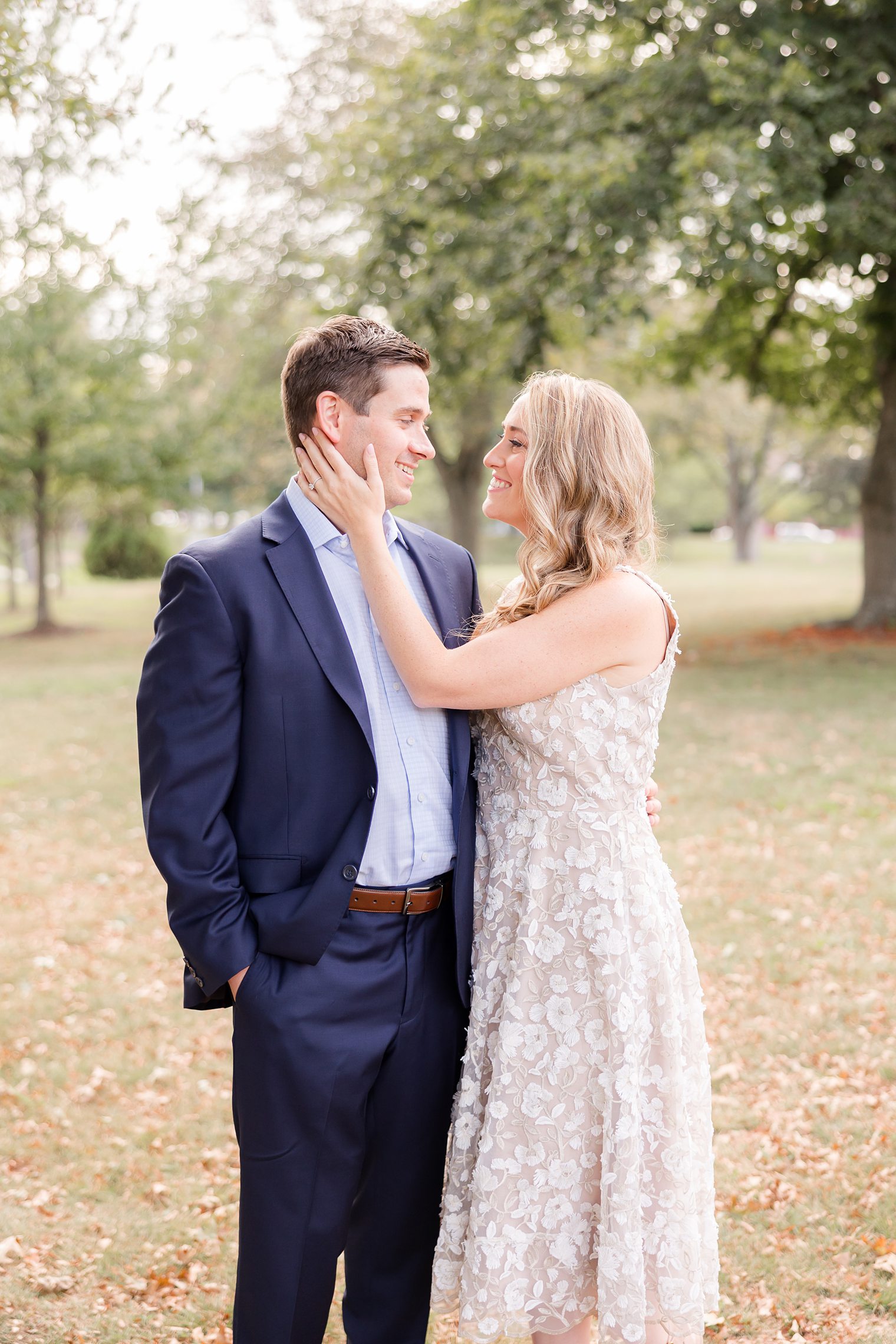 bride putting her hand on her fiancé face