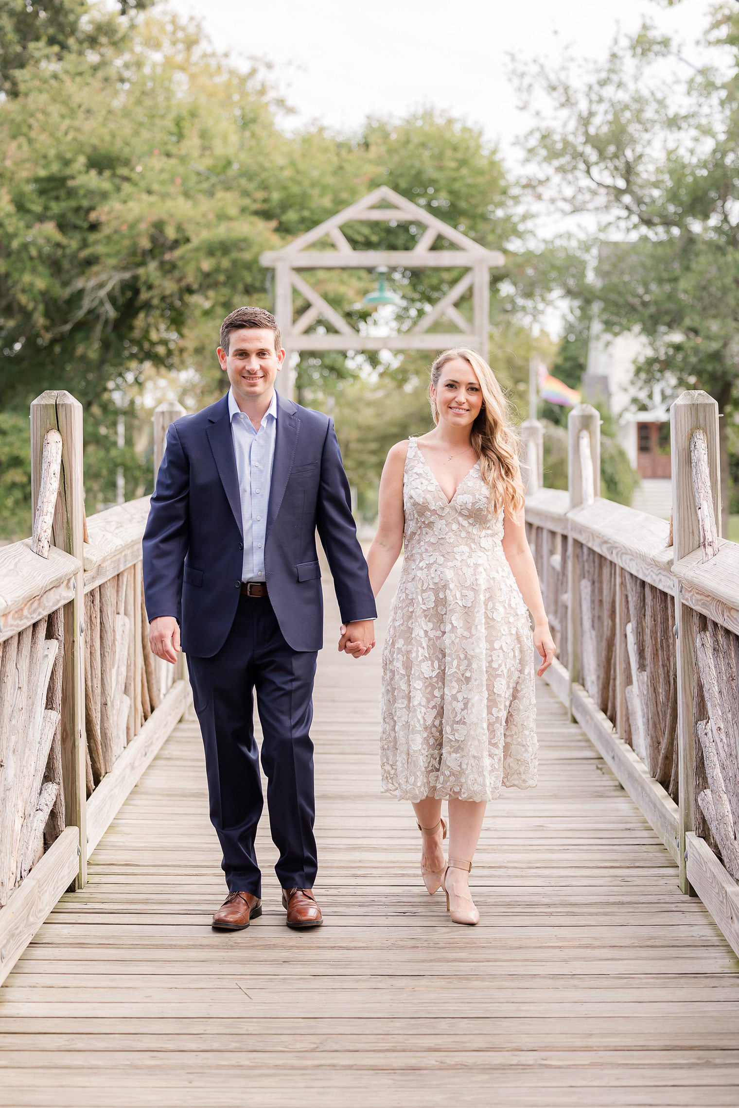 fiancé and bride holding hands at the bride in spring lake