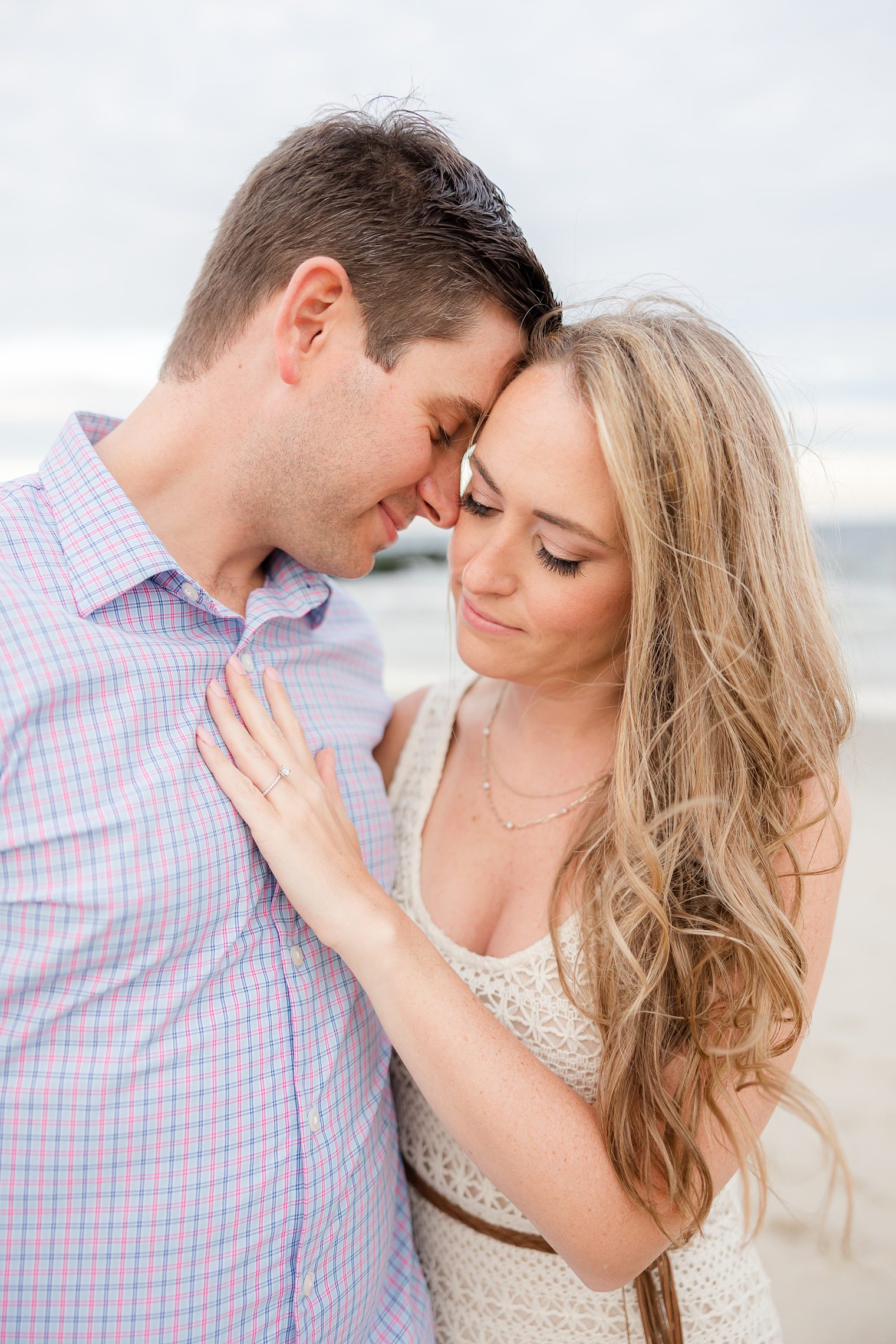 fiancé putting his forehead on bride's face