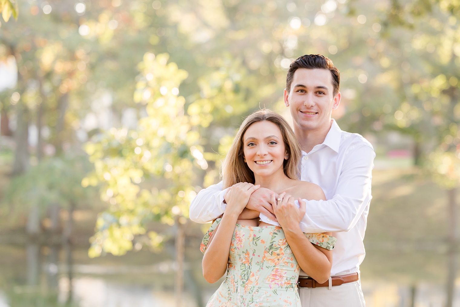 Fiancé hugging his bride from behind