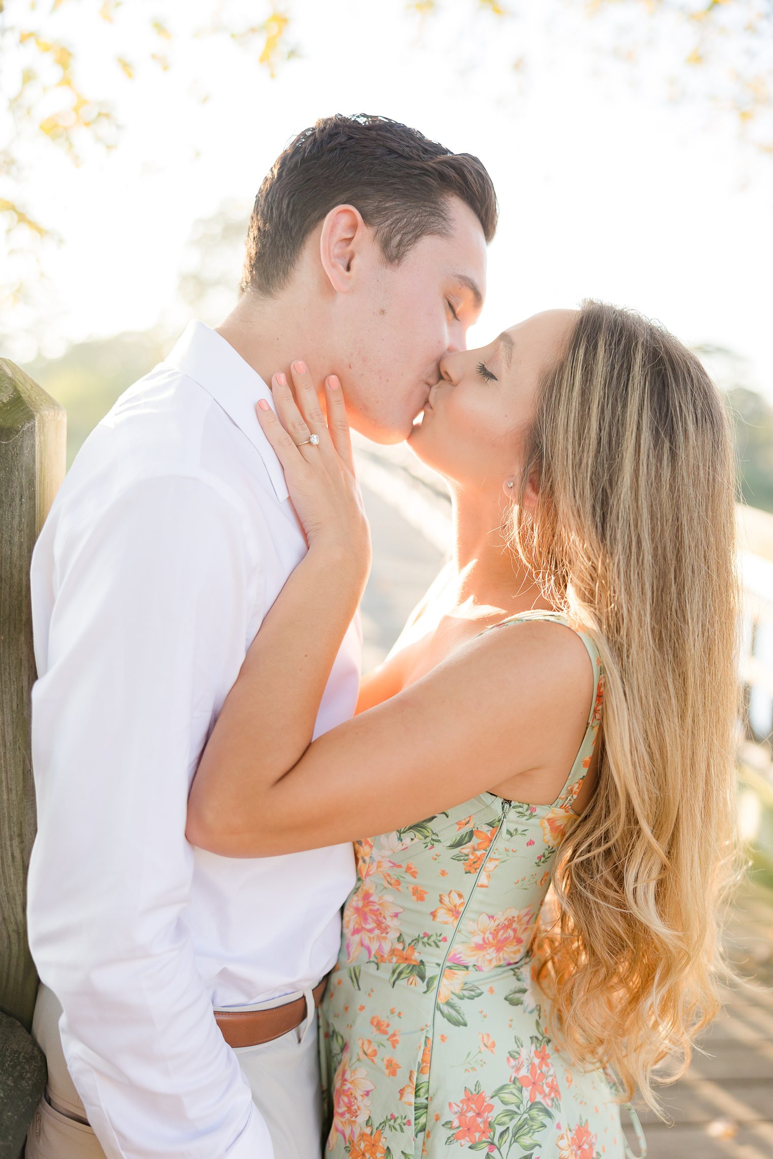 Beautiful couple sharing a kiss at their engagement session at Spring Lake