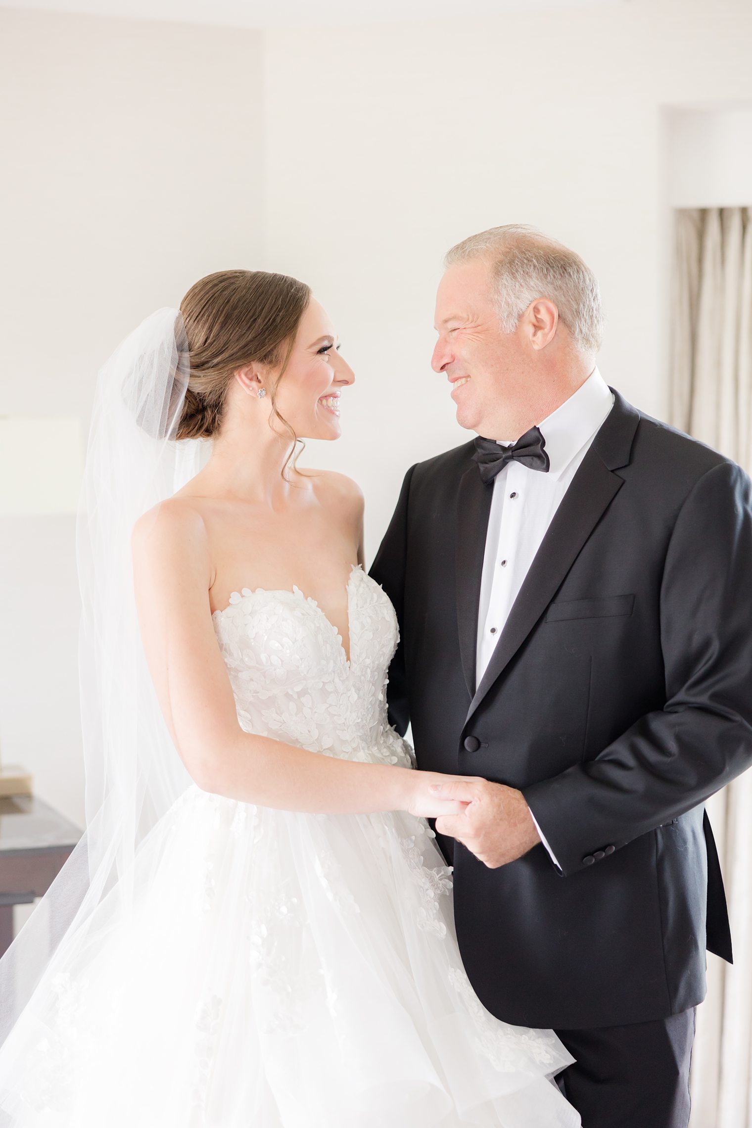 Father and bride looking each other happily