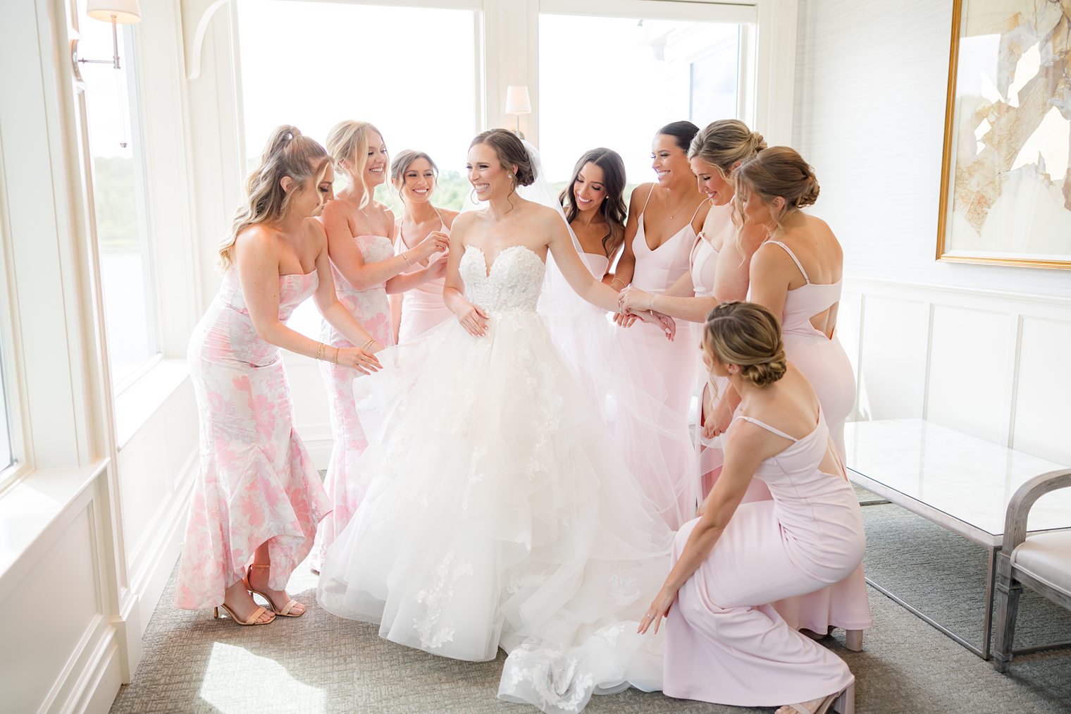 bridesmaids surroundong the bride