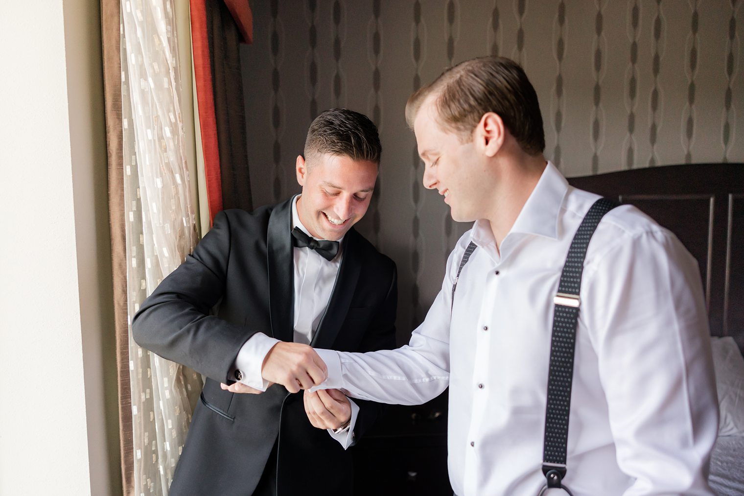 best man helping the groom to get ready