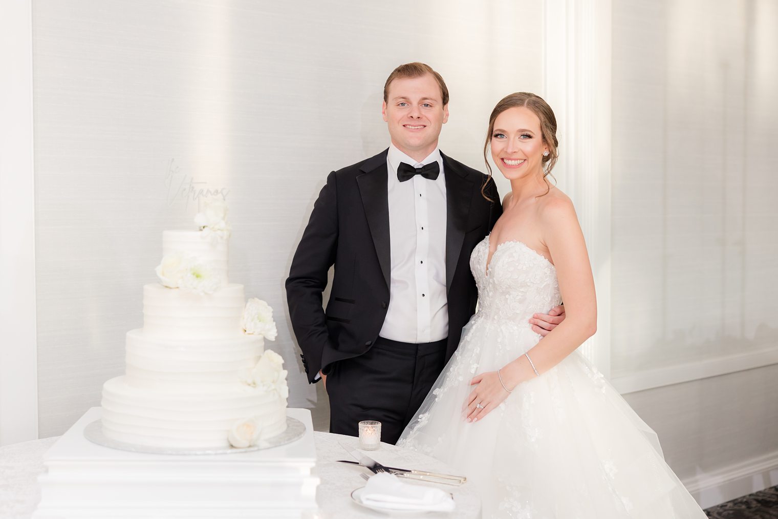 husband and wife posing with their cake