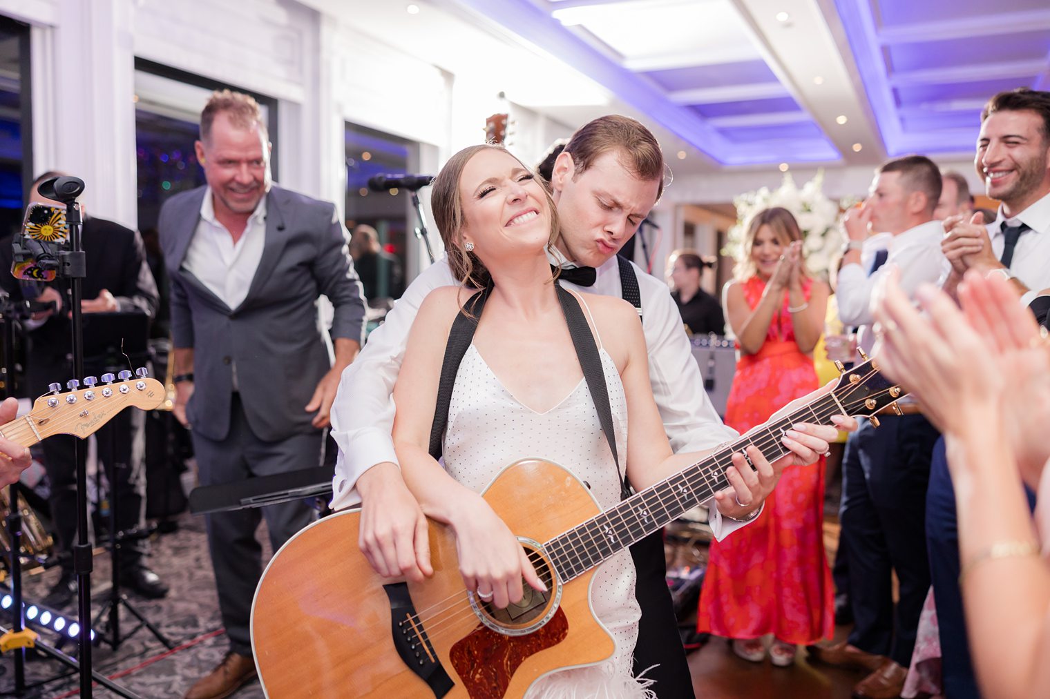 bride having fun playing the guitar