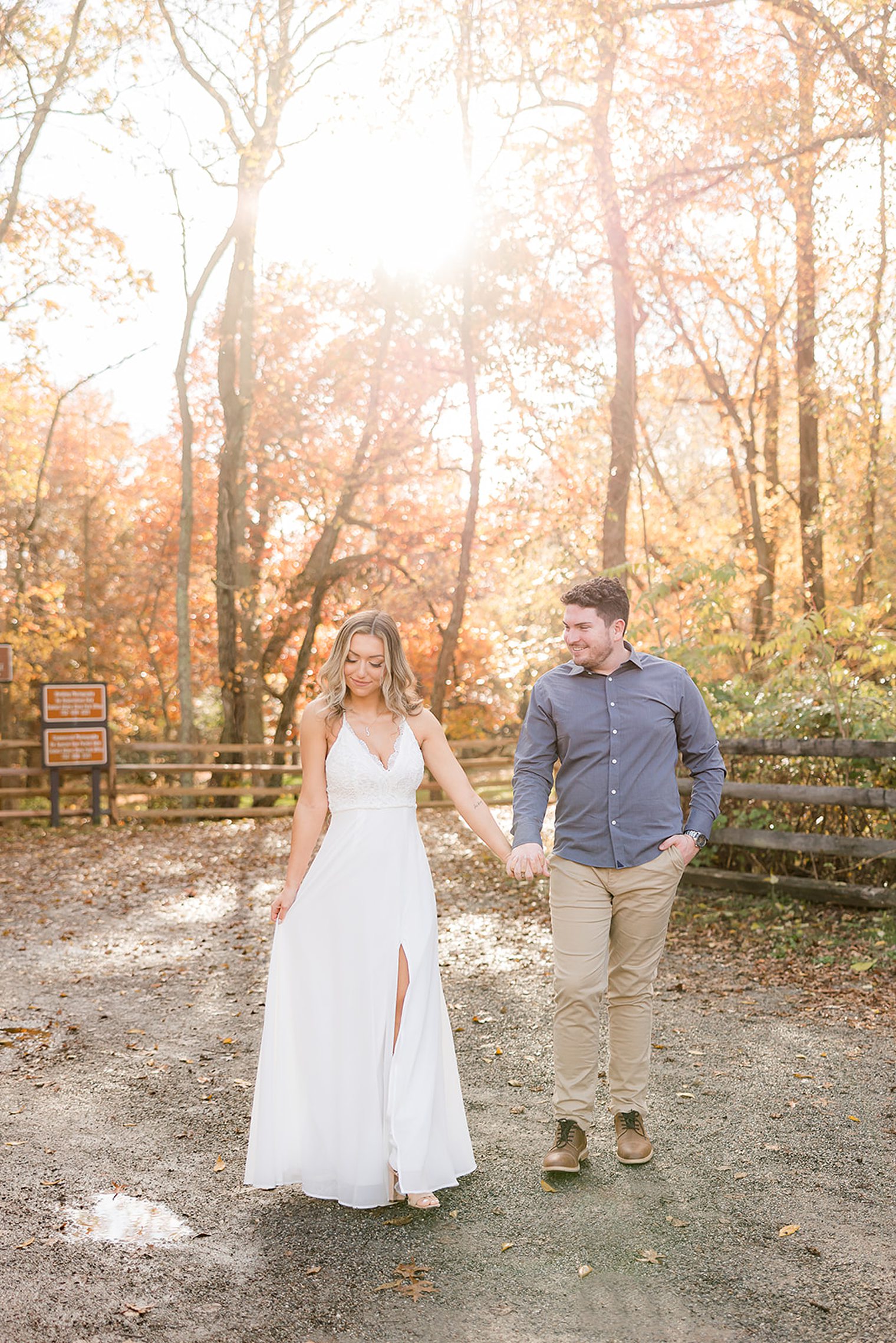 future husband and wife holding hands while fiancé looking at his bride 