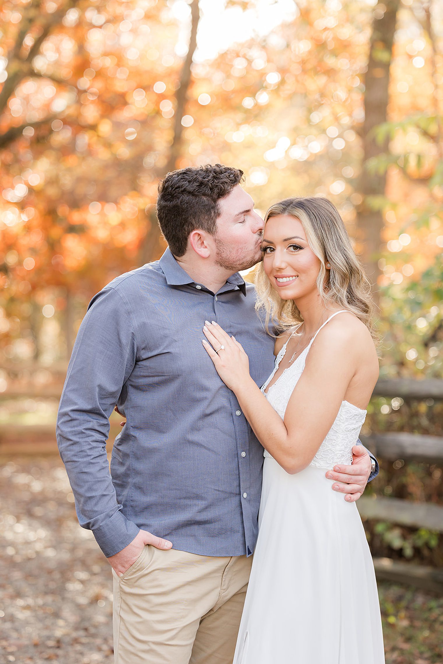 fiancé kissing in the forehead to his bride