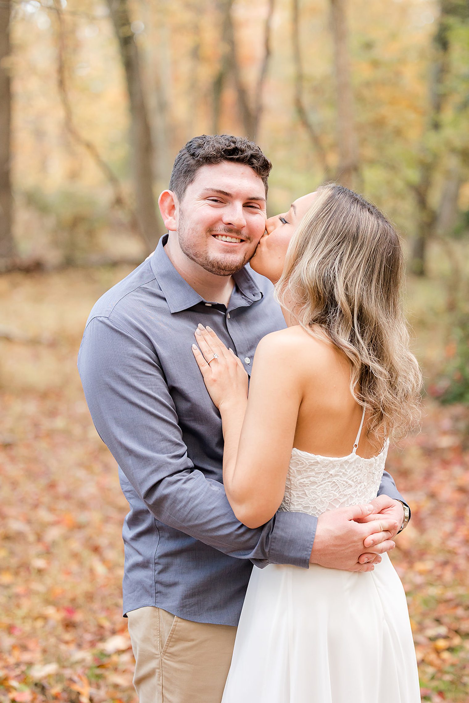 Birde kissing her fiancé on the cheek