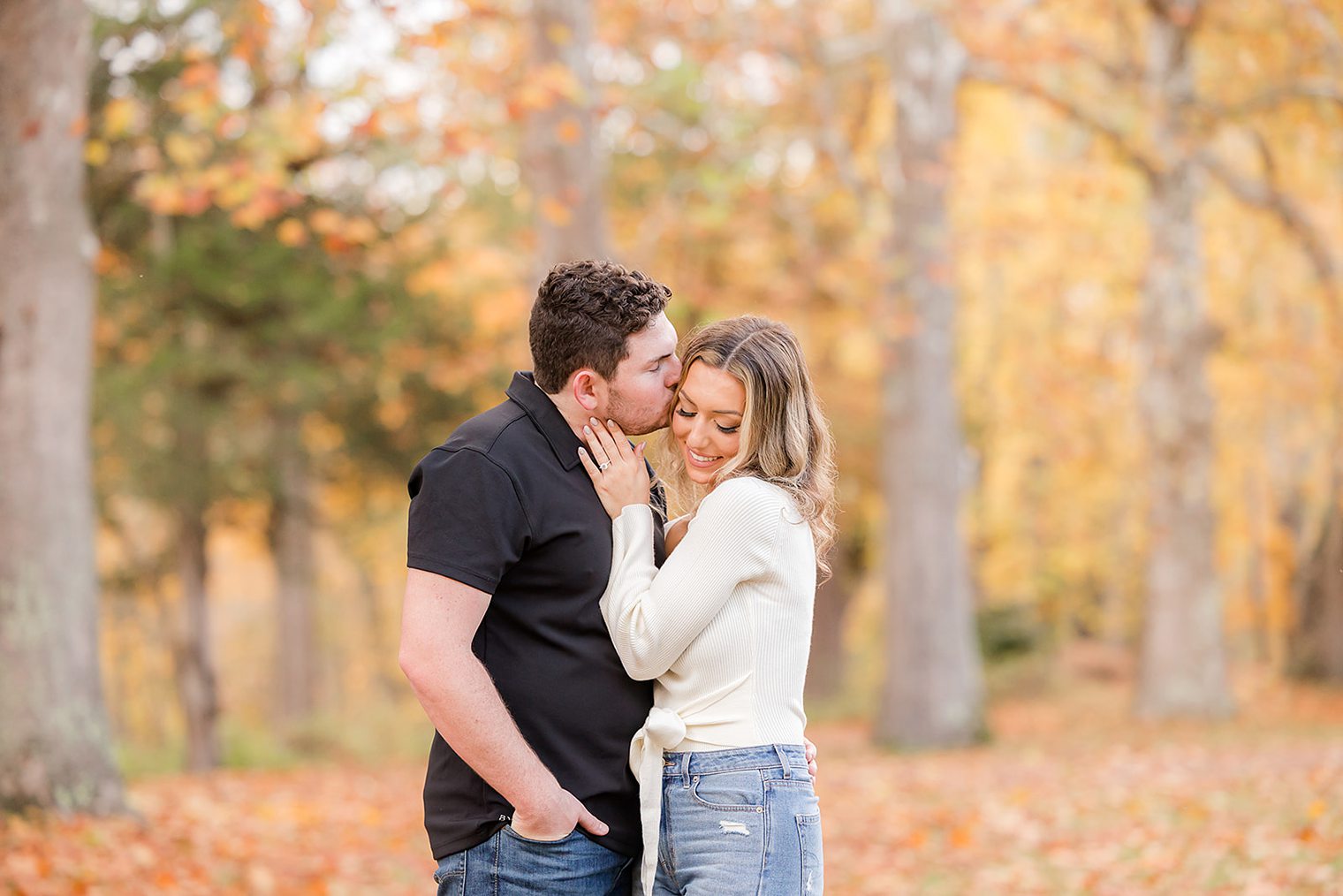 fiancé kissing his bride on the head 