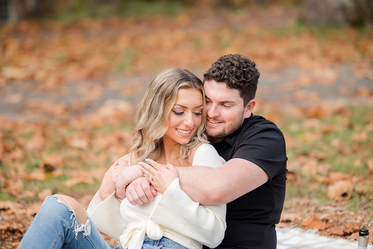 bride and fiancé hugging at Allaire State Park