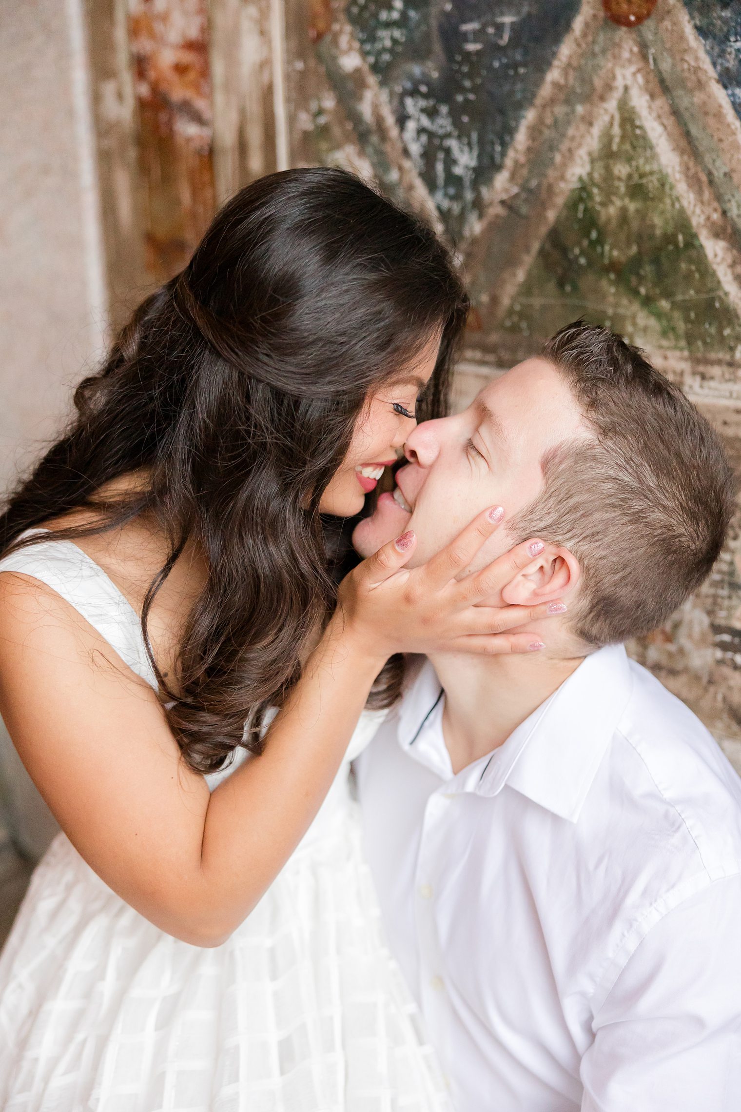 future husband and wife sharing a kiss 