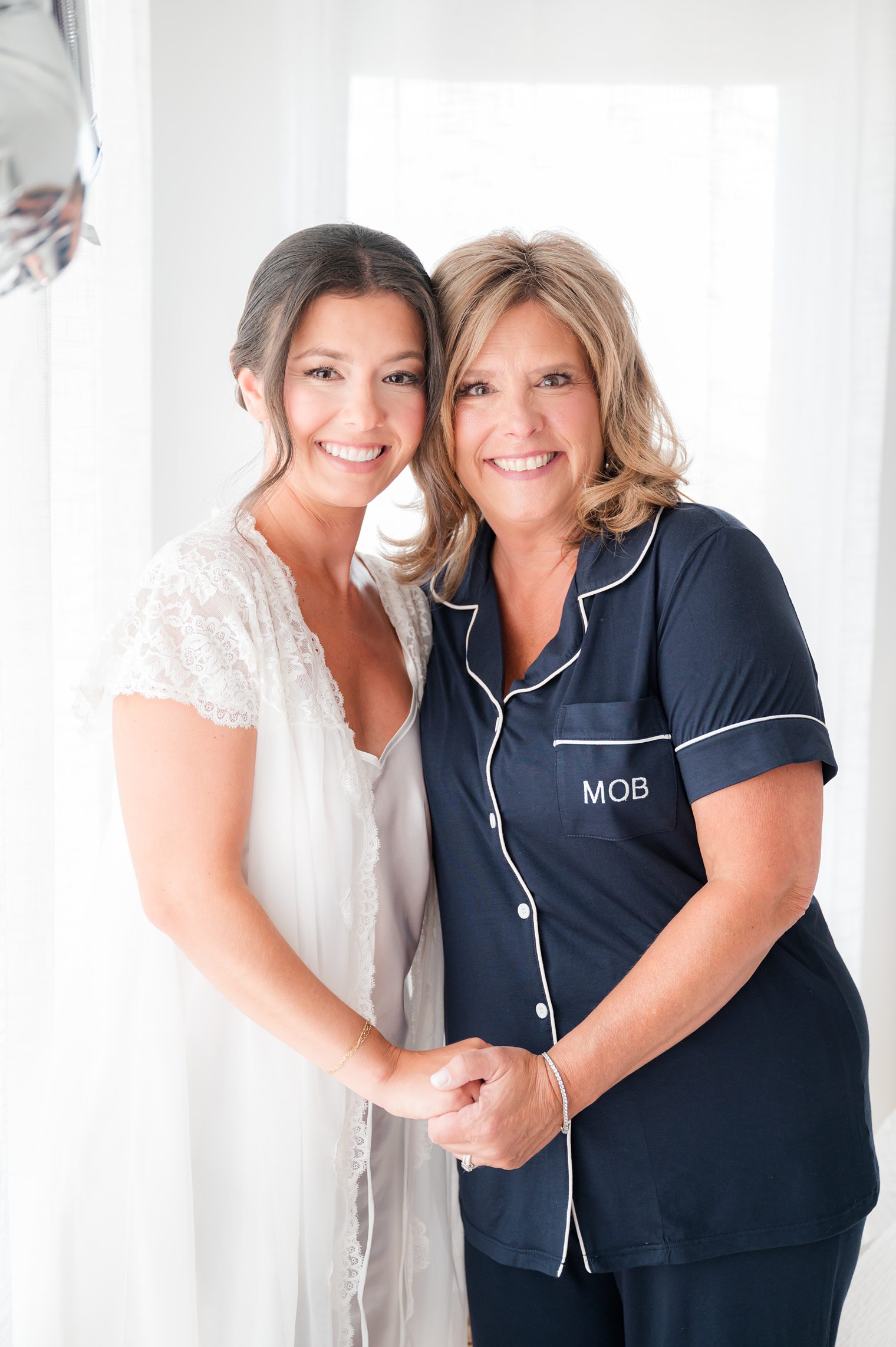 bride and her mother smiling and enjoying the wedding day at Clark’s Landing Yacht Club