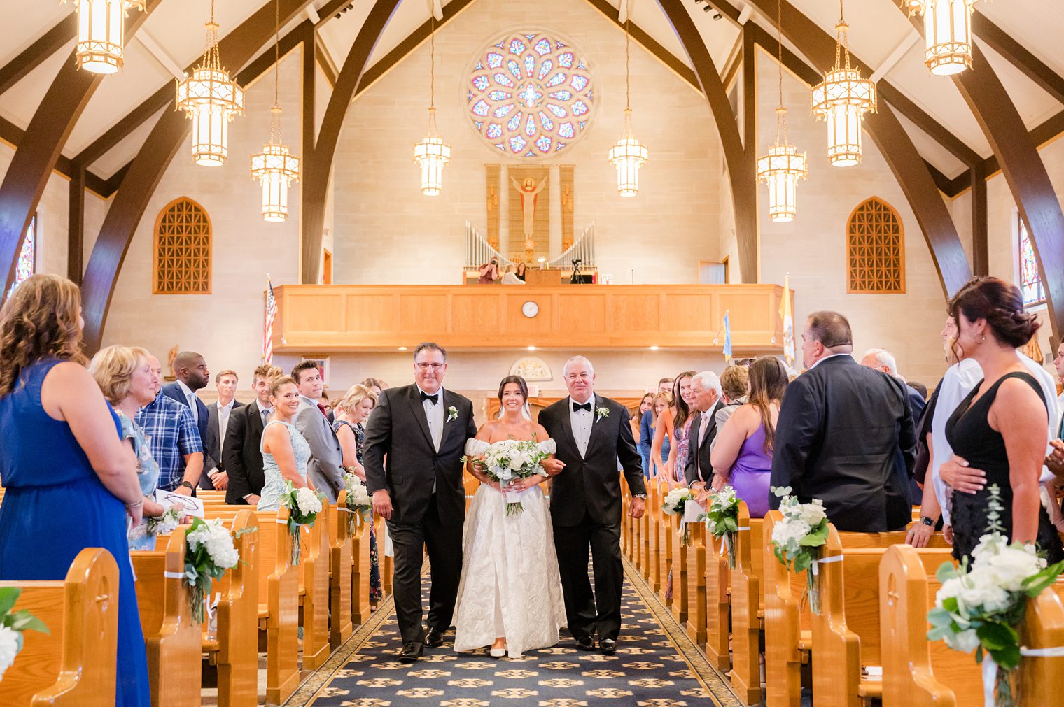 Bride walking in the aisle with her father and grand father