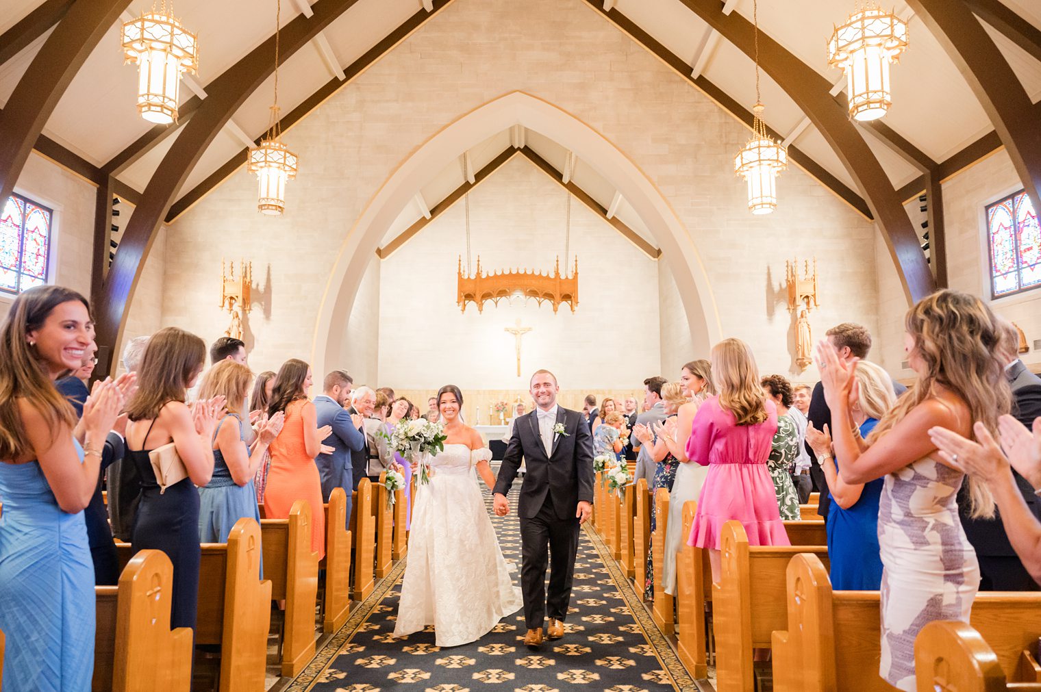 husband and wife walking out the aisle 