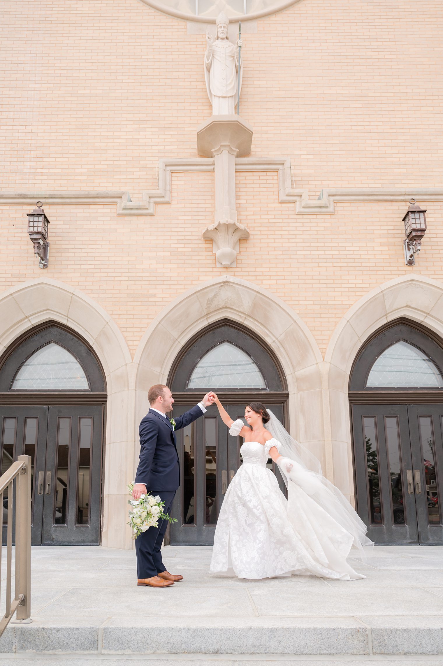 husband and wife holding up their hands 