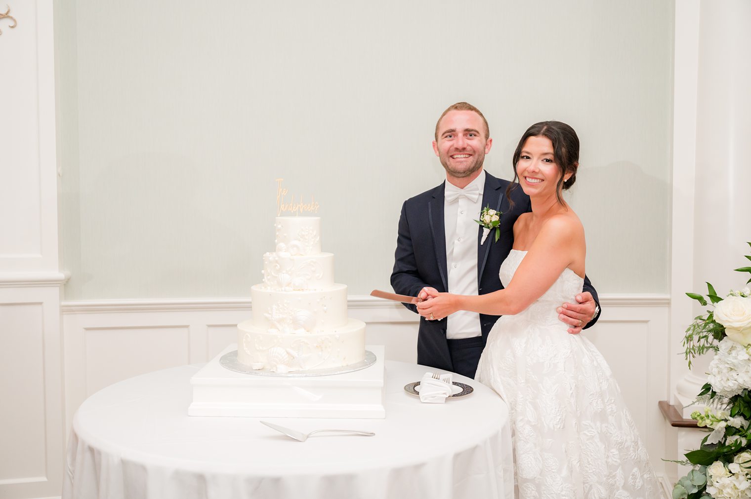 happy couple cutting the cake for the first time as husband and wife 