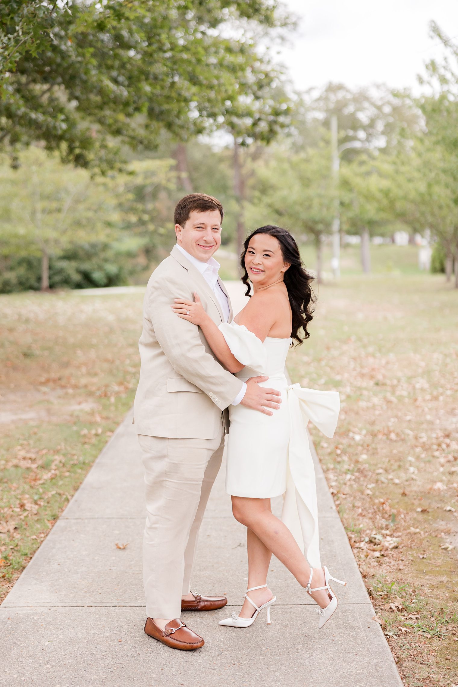 bride and fiancé looking at the camera while they hug each other