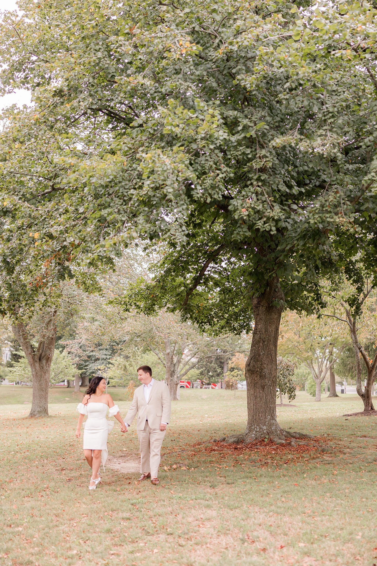 beautiful couple looking each other while they hold their hands 